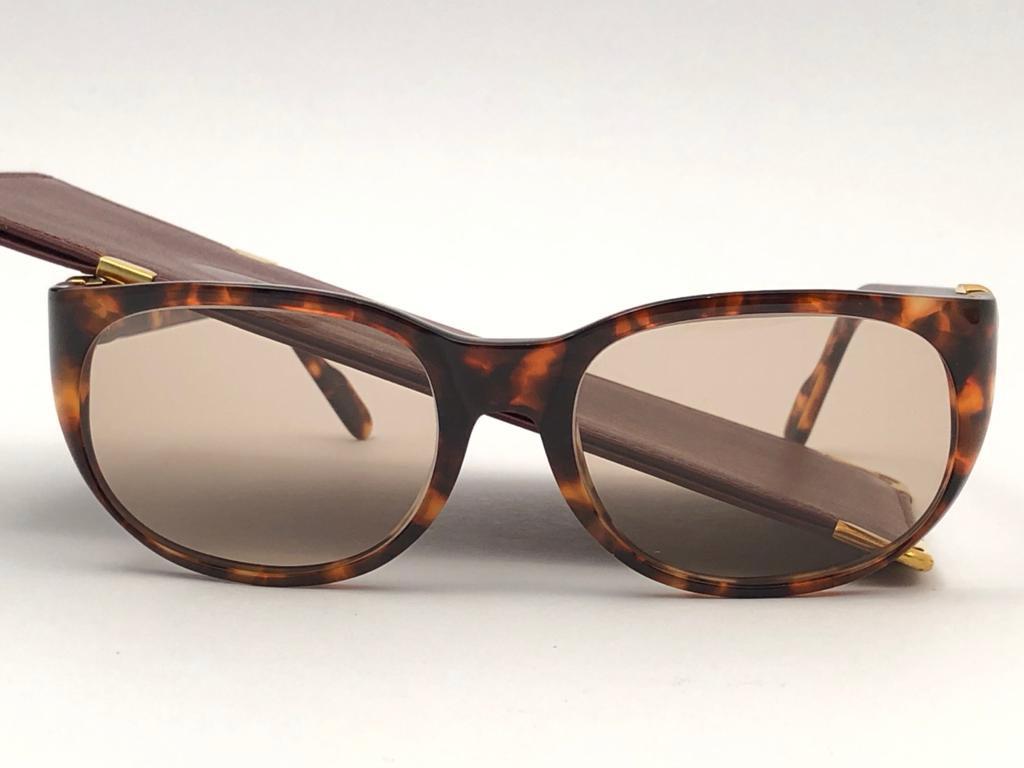Mint Cartier Tentation in tortoise with light brown (uv protection) lenses. 
Frame is tortoise and has the famous real gold and white gold accents. All hallmarks. 
These are like a pair of jewels on your nose with the 18k heavy gold plated accents.