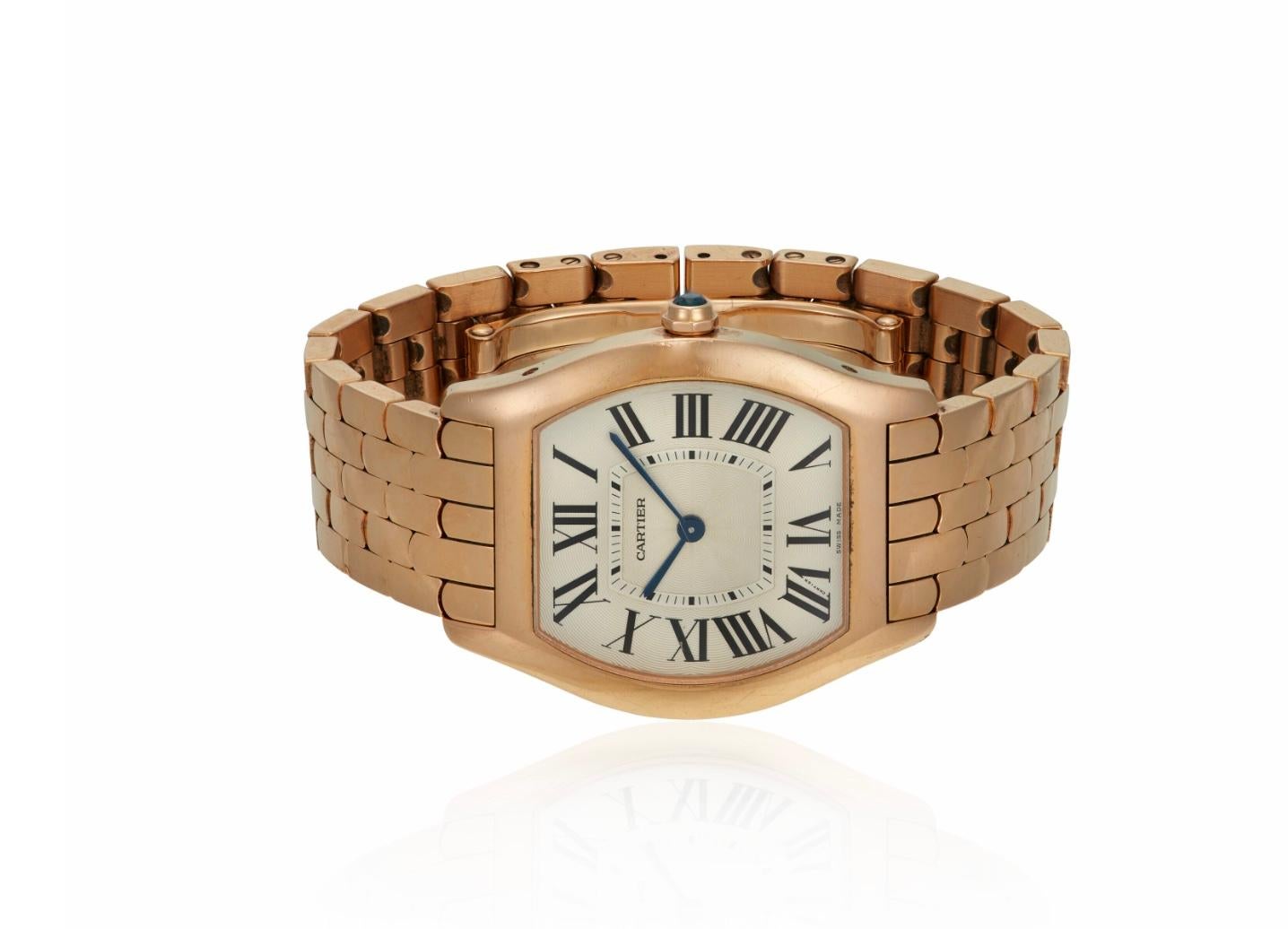 Pre-owned Cartier Tortue ladies wrist-watch in 18kt rose gold. Chic and slim 8.6mm thick case with integral link bracelet and hidden fold-over clasp. Tonneau-shaped 31mm dial with roman numeral hour markers and finely detailed guilloche dial with