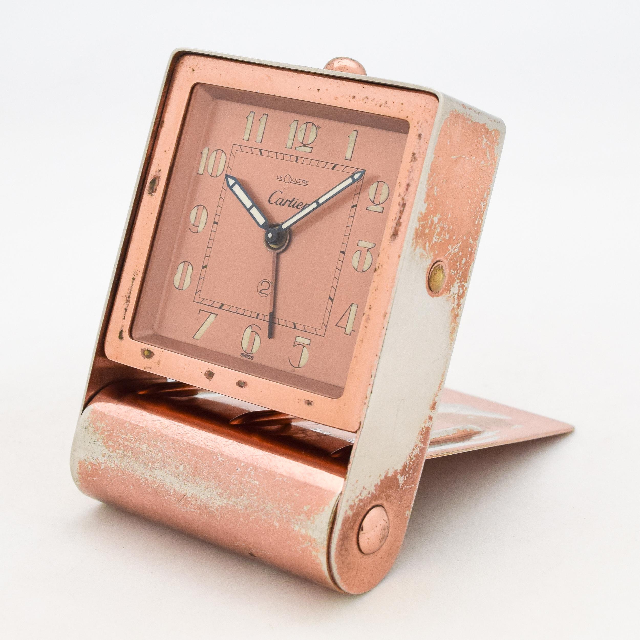 1940's Vintage Cartier Travel Alarm Clock Copper Plated with Movement Made By Le Coultre with Original Salmon/Copper Color Dial with Original Black Leather Carrying Case. Triple Signed Le Coultre. 58mm x 58mm lug to lug (2.28 in. x 2.28 in.). 7