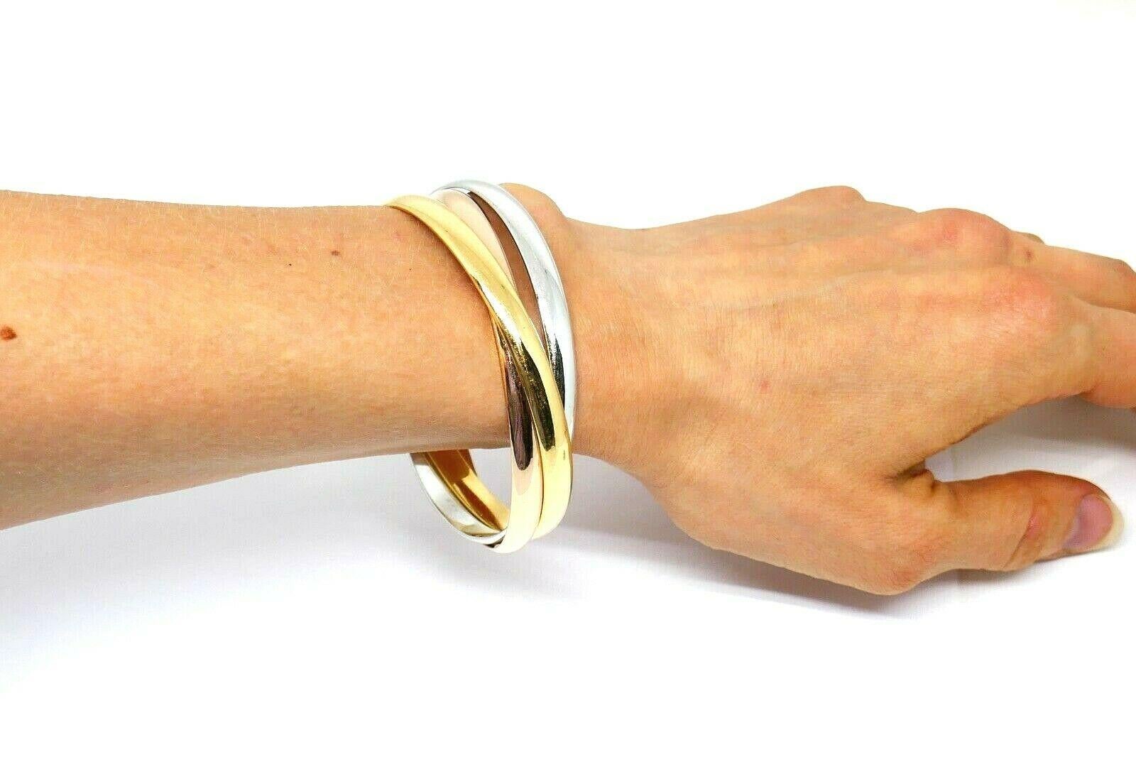 Iconic Cartier Trinity bangle bracelets made of 18k yellow, white and rose gold. Forever chic design with a great vintage touch.  
Measurements: inner circumference is 8