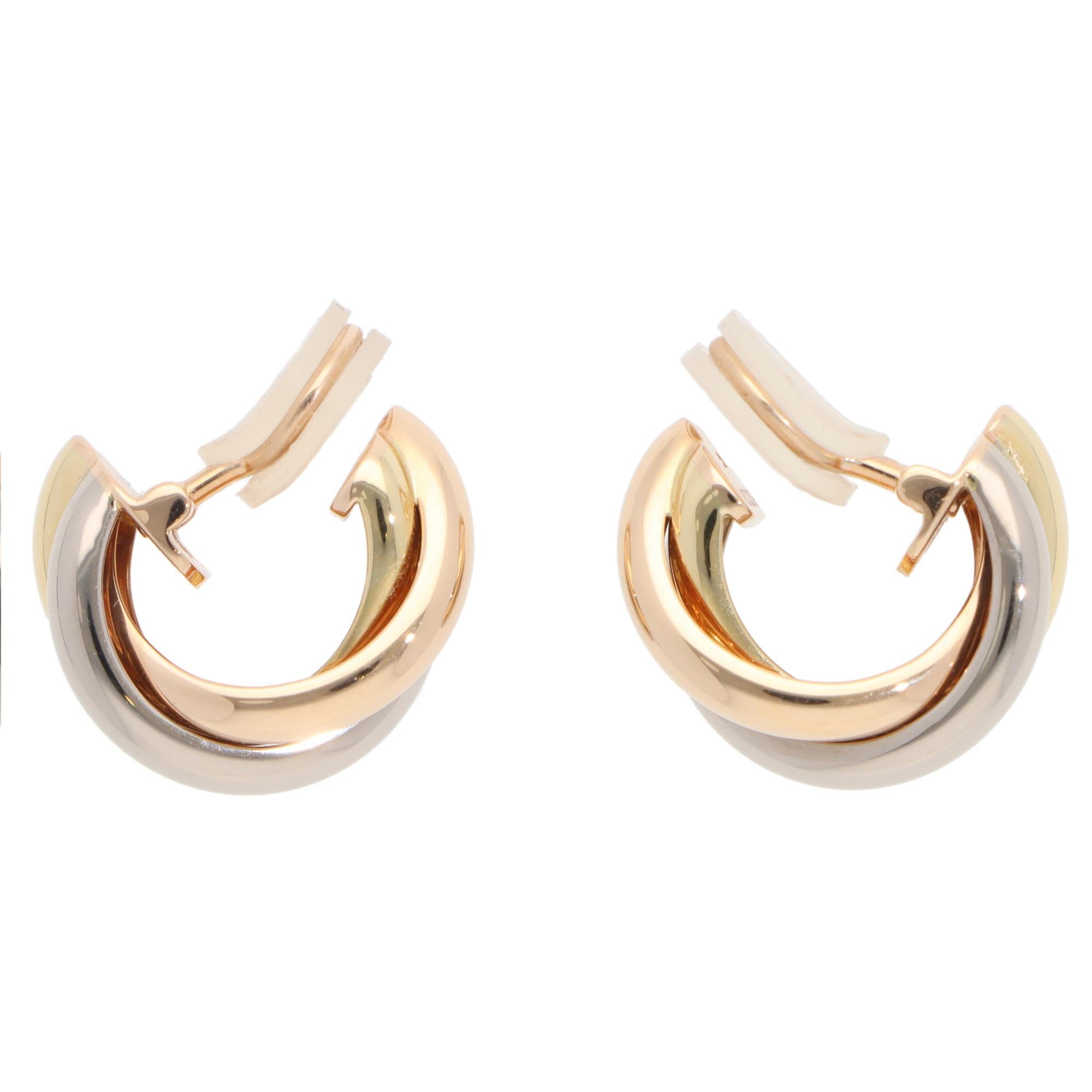 A classic pair of vintage Cartier trinity hoop clip earrings set in 18k yellow, rose and white gold.

Each hoop is set in the iconic trinity design and is composed of three 3-millimetre bands, which are soldered together to create the hoop. They are
