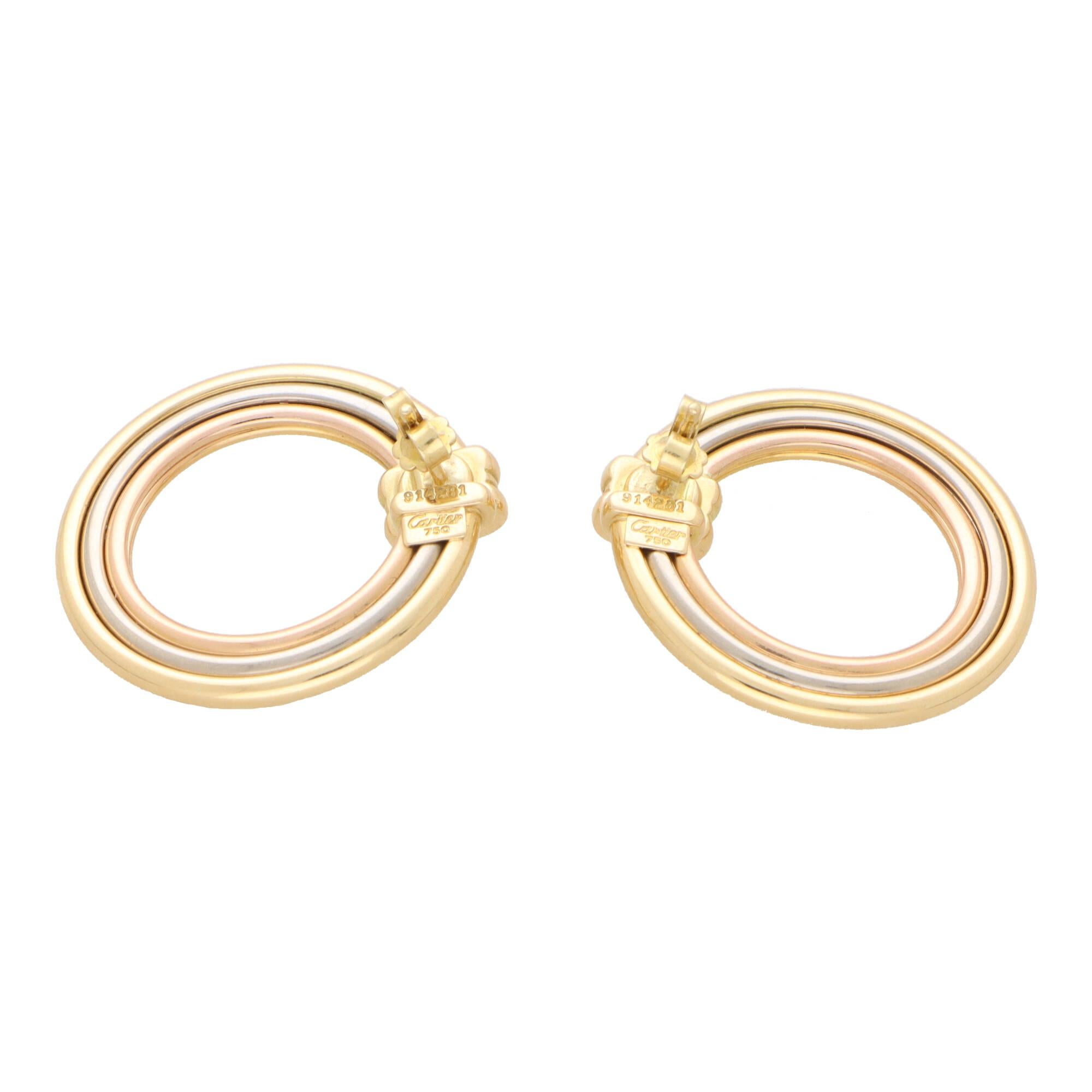 A fantastic pair of vintage Cartier trinity hoop earrings set in 18k yellow, rose and white gold.

Each earring consists of a large half hoop, designed in the iconic trinity gold colours. The earrings are designed to hug the lobe giving the illusion