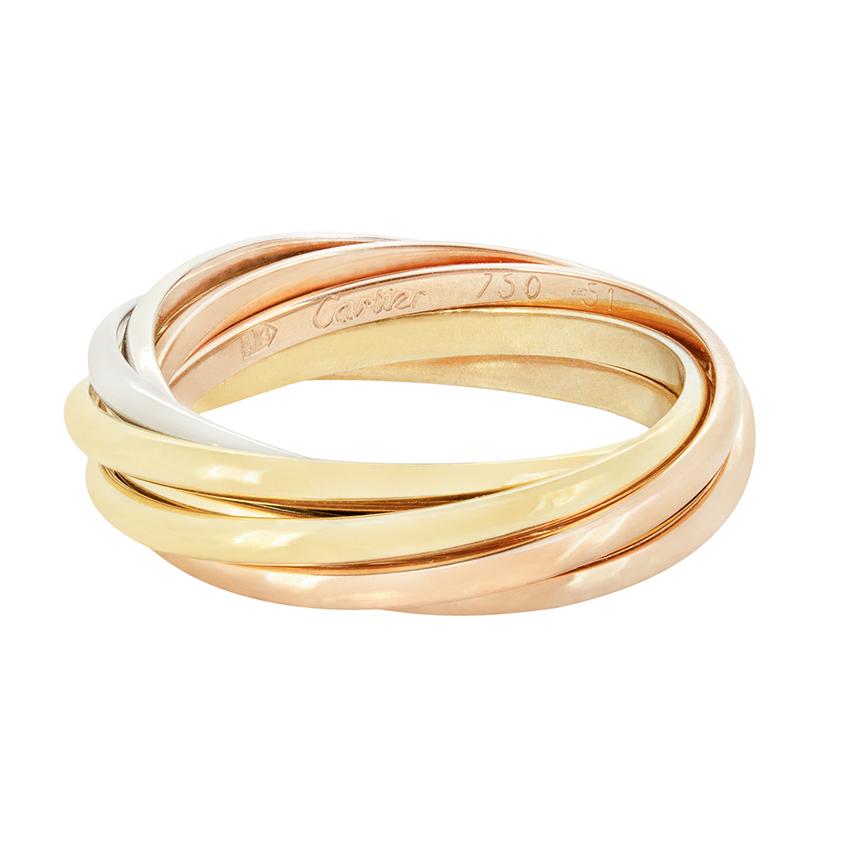 This Cartier ring is from their ‘Trinity’ collection. Three interlocking gold bands form the ring, one is made of 18 carat yellow gold, 18 carat white gold, and 18 carat rose gold.  All the original ‘Cartier’ makers marks are visible around the