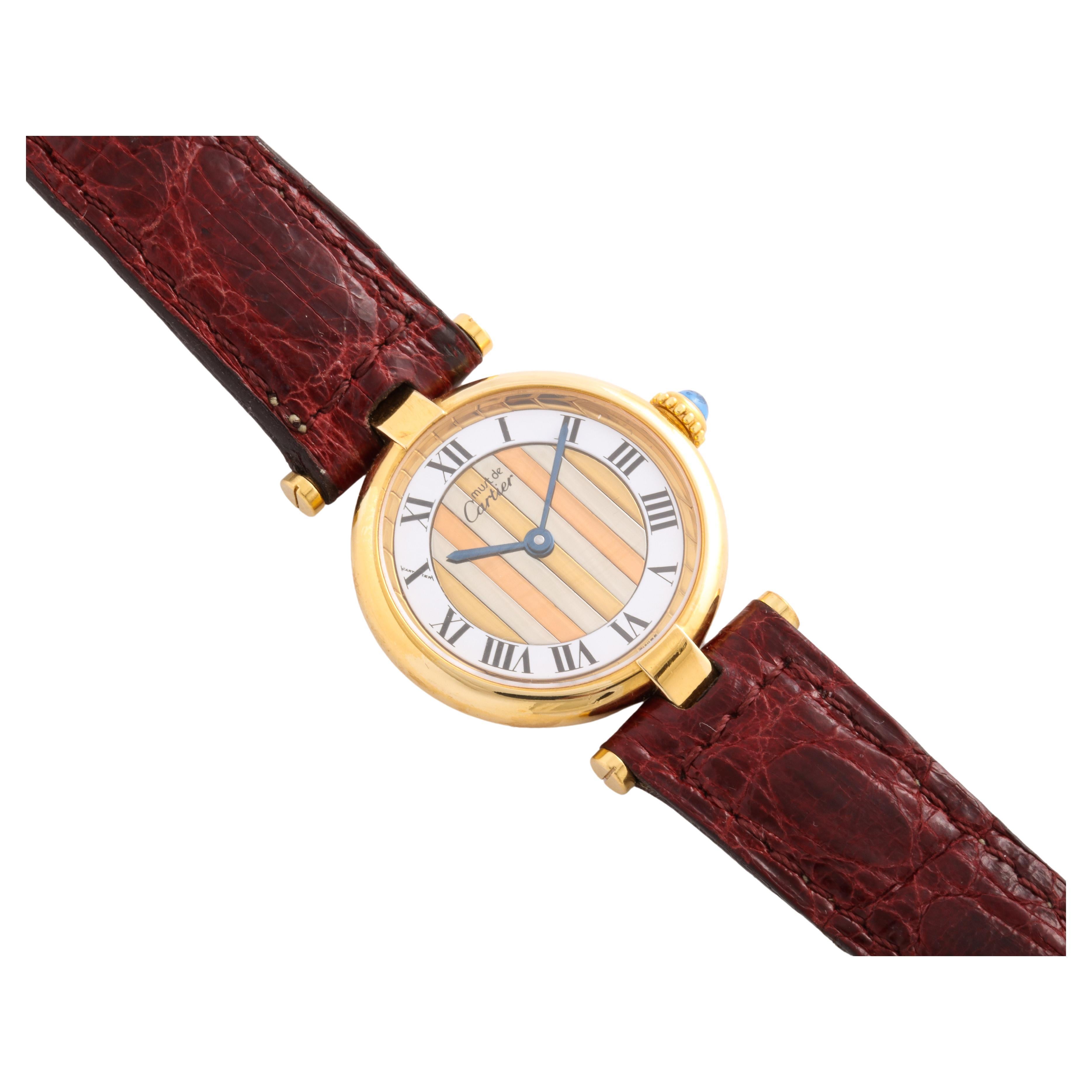 An authentic Cartier Round Faced Trinity watch in a classic Cartier design with Sapphire stem and executed in Vermeil from Cartier Paris. The Trinity design stands for fidelity, friendship and love. It is difficult to find fine Vintage Watches and