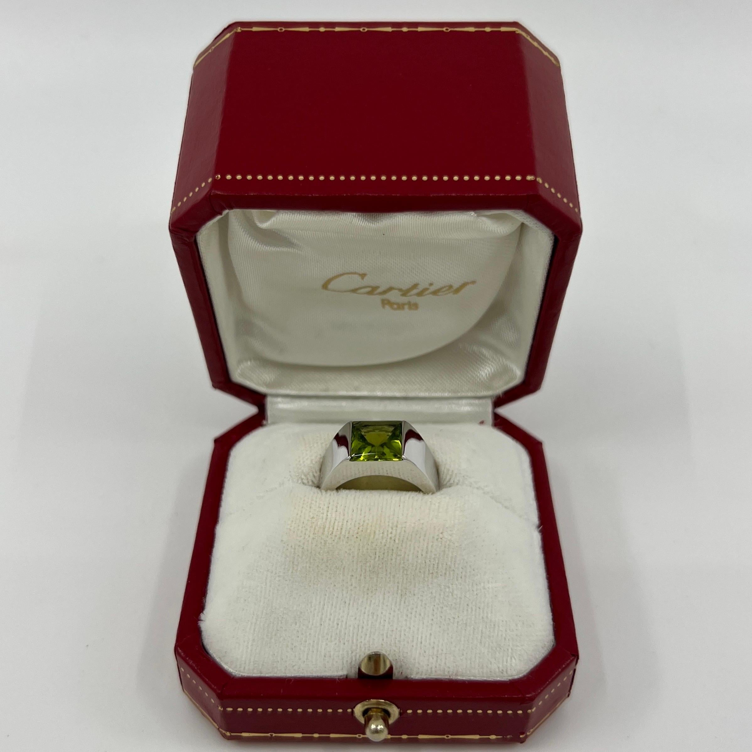 Vintage Cartier Vivid Green Peridot 18 Karat White Gold Tank Ring.

Stunning white gold ring with a large 8mm tension set vivid green peridot. 
Fine jewellery houses like Cartier only use the finest of gemstones and this peridot is no exception. A