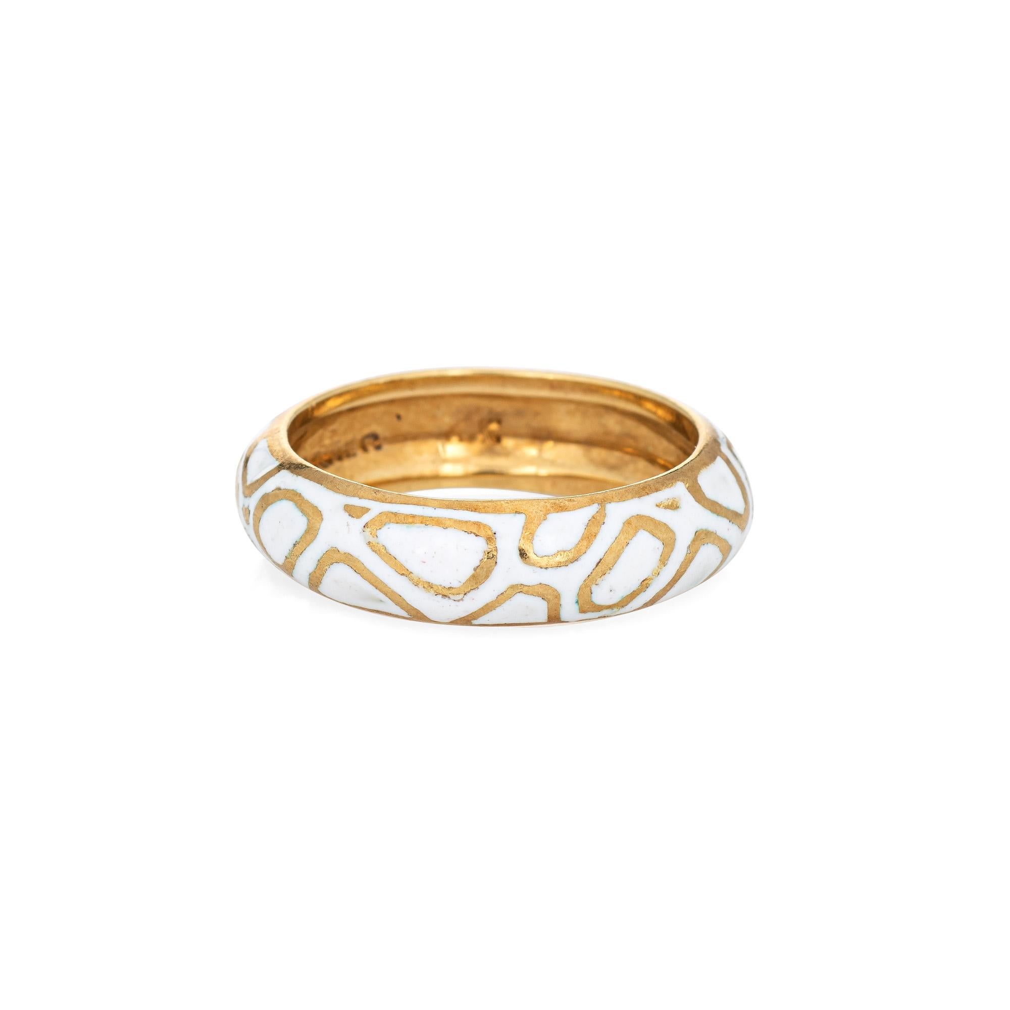 Vintage Cartier enamel ring crafted in 18k yellow gold (circa 1960s to 1970s).  

The Cartier ring features an abstract white enamel pattern around the entire band. The band measures 5mm wide (0.19 inches). The ring is great worn alone or layered