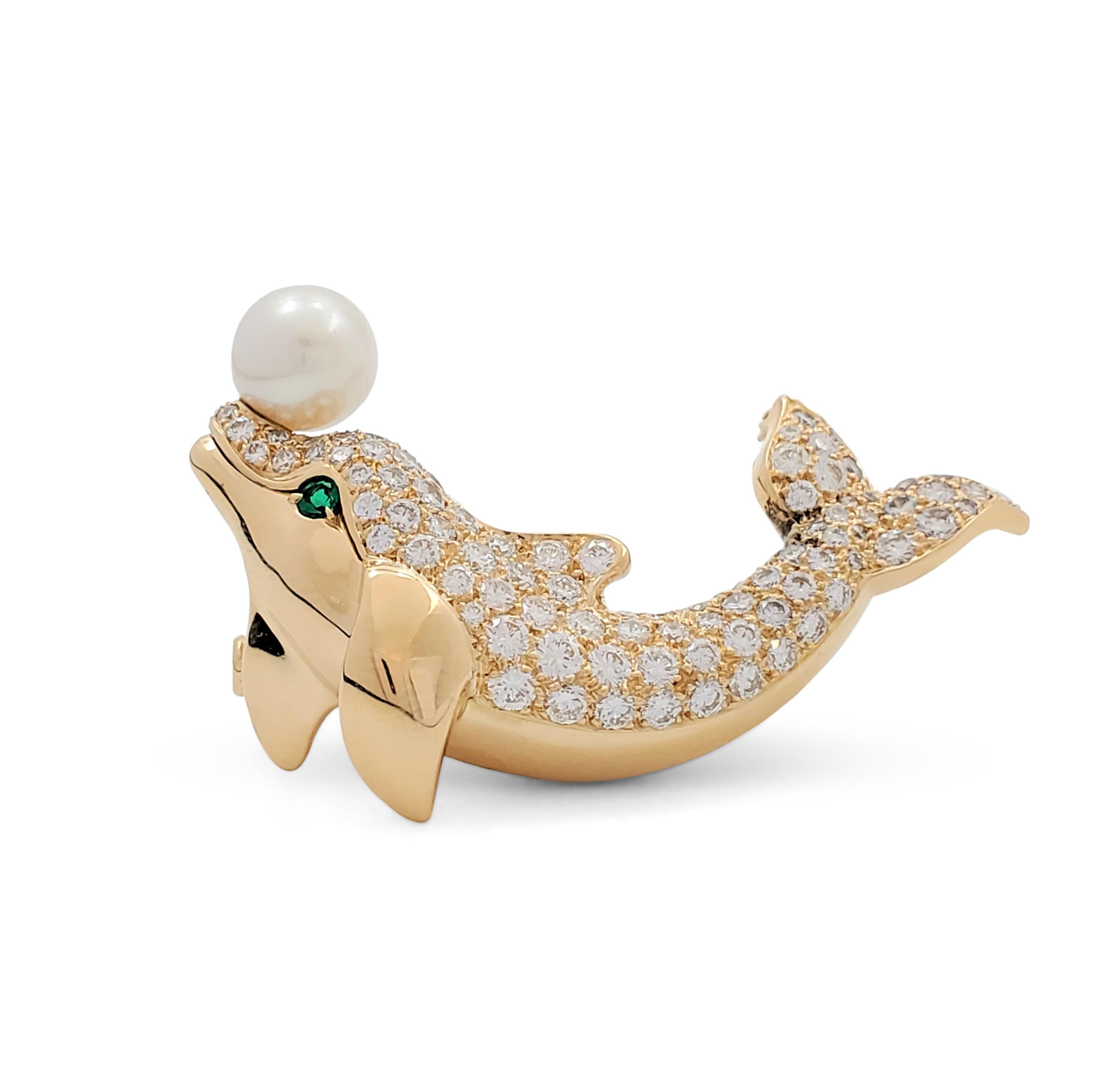 Authentic whimsical Cartier brooch crafted in 18 karat yellow gold to resemble a dolphin. Pave set round brilliant diamonds weighing an estimated 3.60 carats (E-F, VS) highlight the body of the dolphin. The design is completed by a single vivid