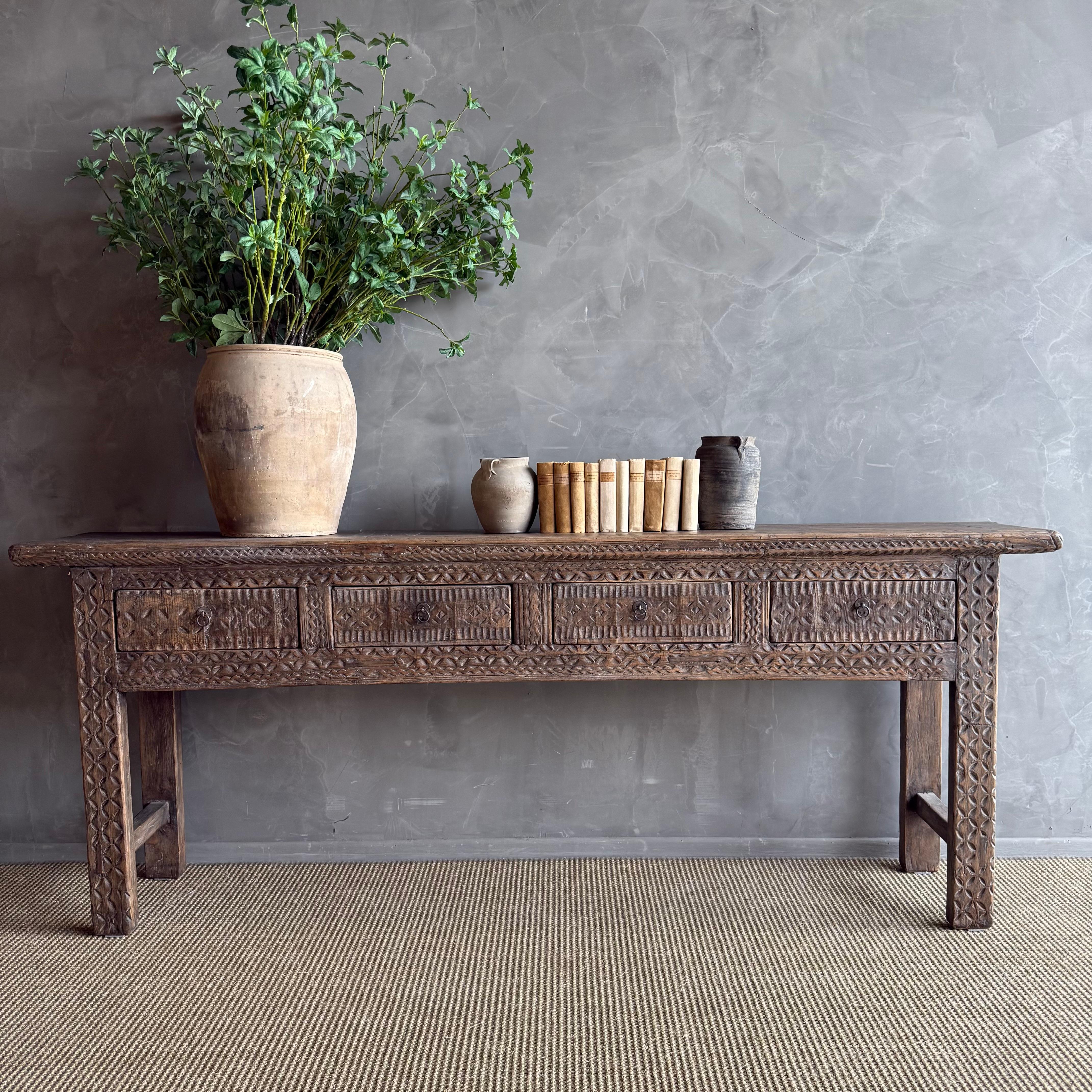 This charming vintage elm wood console is a one-of-a-kind piece with beautiful age and patina that adds character to any space. Its patina painted elm wood finish showcases the natural beauty of the wood, while the solid elm wood original hardware