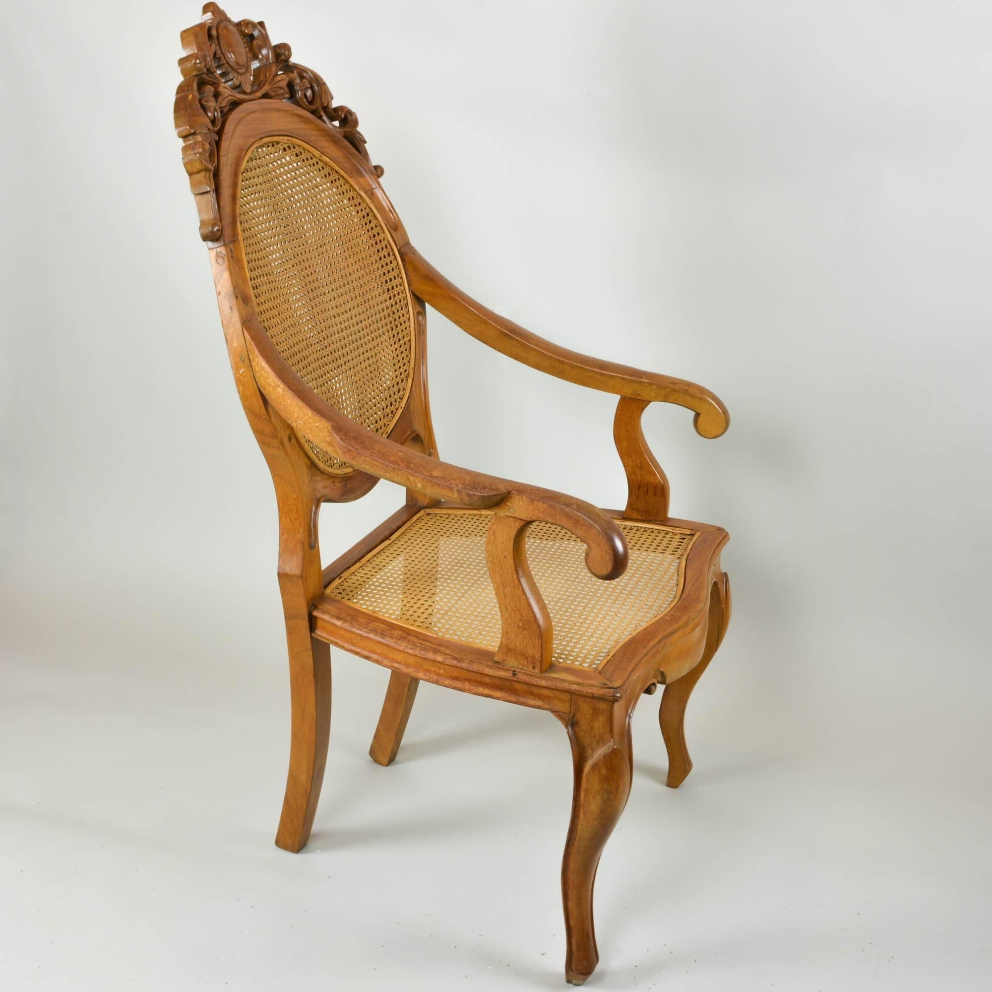We couldn't resist picking up the carved back chair with a double caned back. The richness of the wood caught our eye and the quality of the caning made it a must have. Very comfortable with slightly reclining back and wide seat. The arms on the
