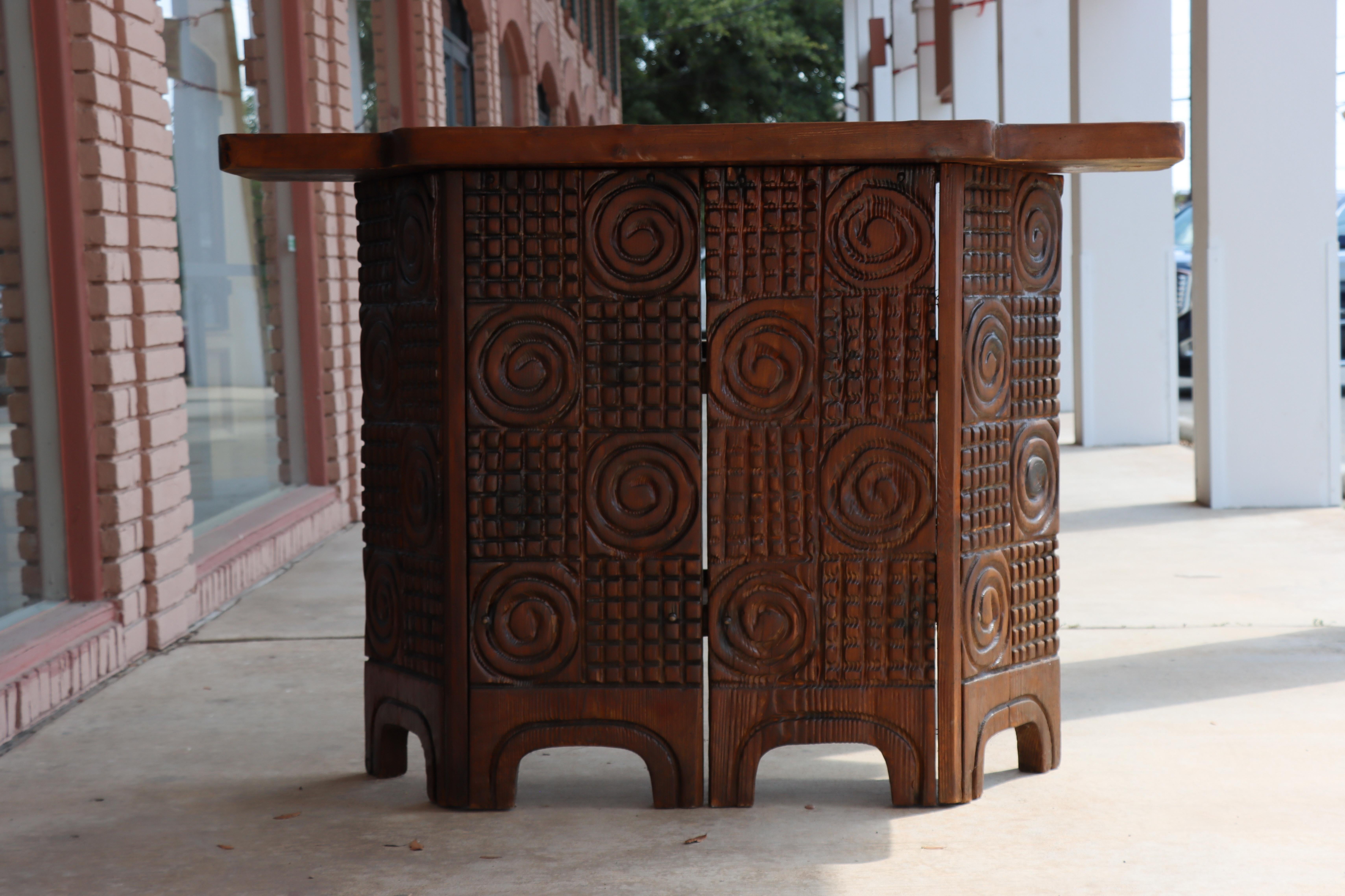 A standing “chateau” bar designed by William Westenhaver and Crafted by the West Indian Trading Company (Witco), 1959.

 This example is made from sturdy, dark-stained cedar and features two spacious shelves thoughtfully designed to hold your