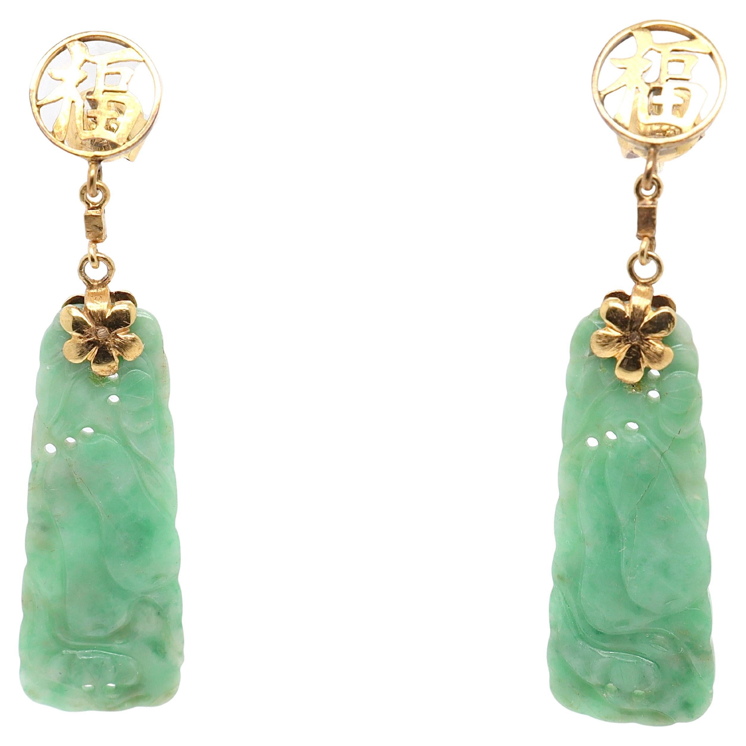A pair of vintage Chinese gold & jade earrings.

In 14K gold.

Each jade is decorated with carved pears and suspended from findings in the shape of the Chinese character for 