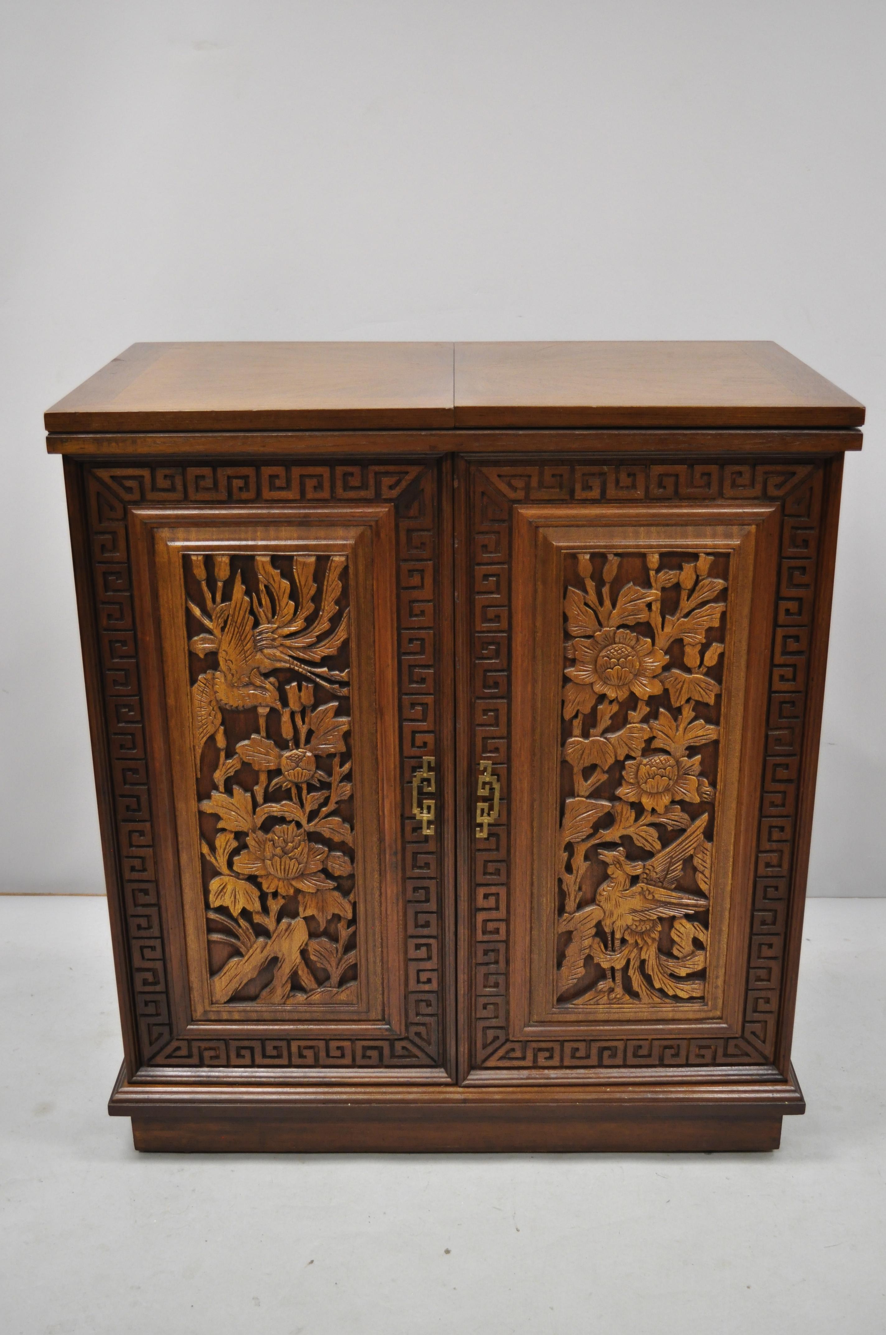 Vintage carved Chinese oriental folding expandable bar liquor cabinet server. Item includes sunburst flip top, green inset marble, fully opens to impressive surface, phoenix and flower carvings to front and back, plenty of interior storage, rolling