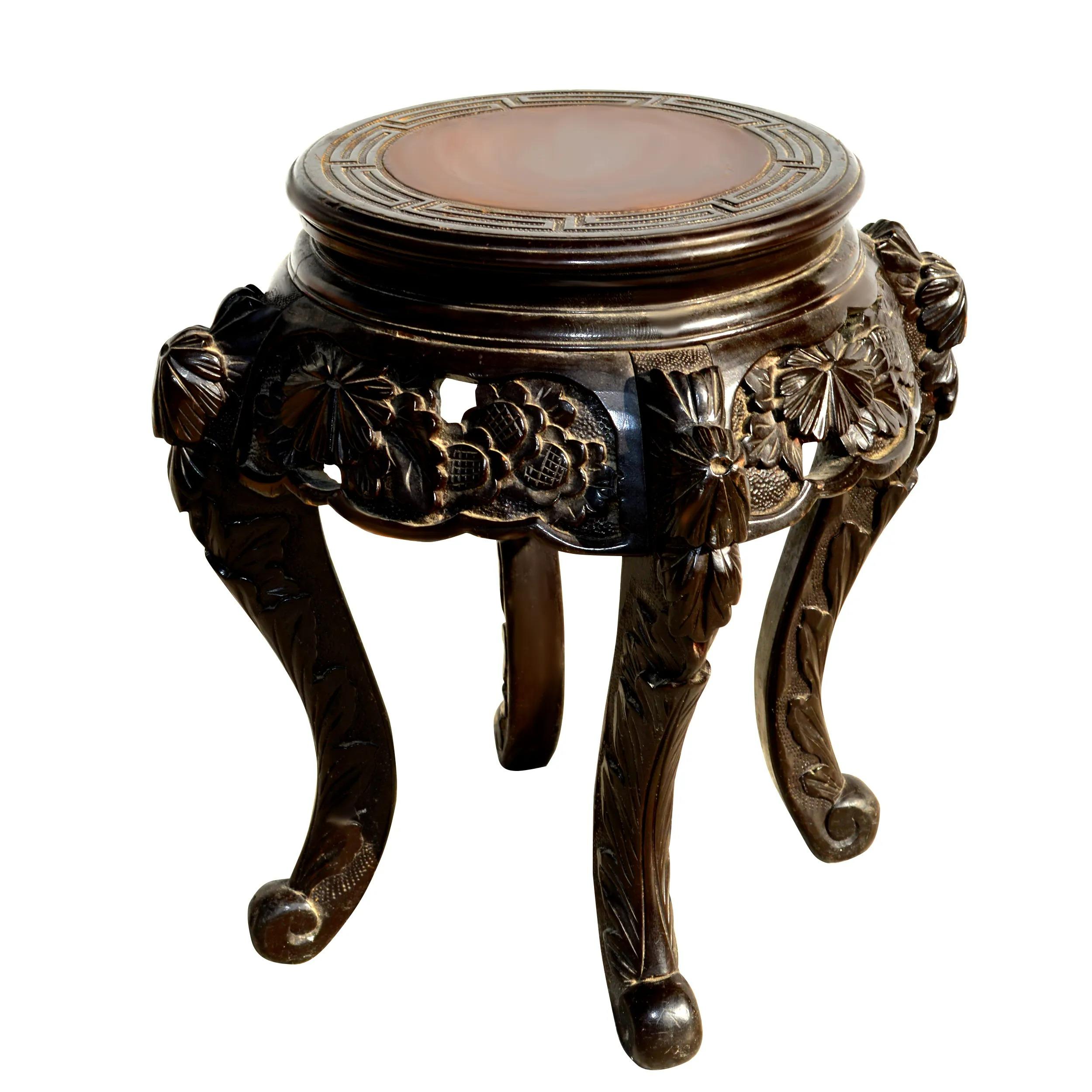 Vintage Carved Chinese Side Table

Vintage mid-century ebonized pedestal or side table.
Intricately carved floral motifs on apron and cabriole legs.
 