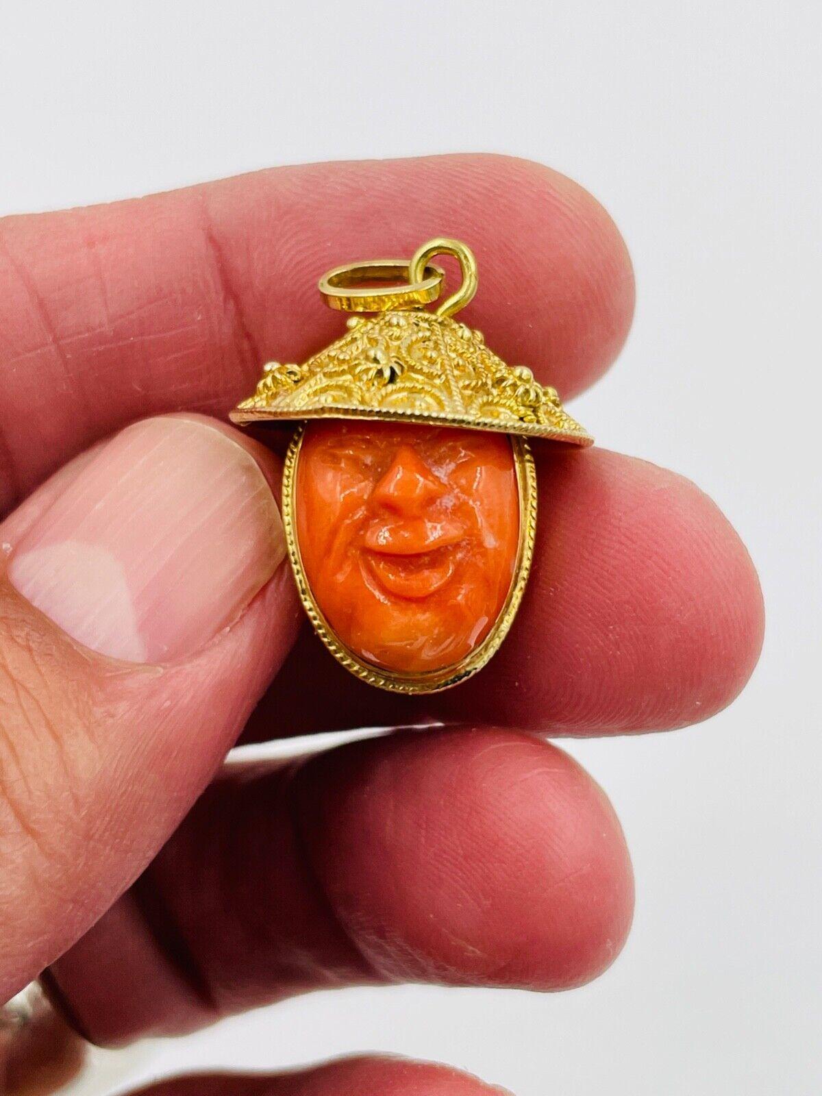 1950s Vintage two carved coral faces yellow gold charm pendant made in 18k yellow gold.  Very cute!

WEIGHT: 11 grams 

DIMENSIONS: 1-1/8” long X 3/4” wide

CONDITION:  high magnification photographs show considerable design details, and the item is