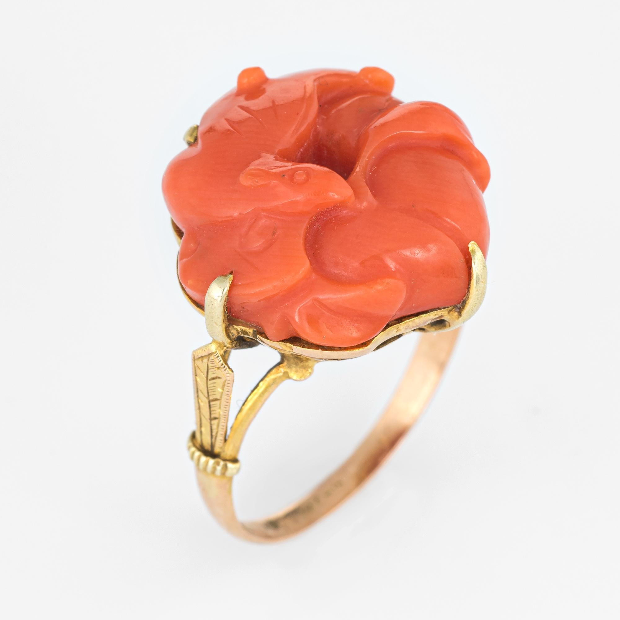 Stylish vintage carved coral ring (circa 1950s to 1960s) crafted in 14 karat yellow gold. 

Carved coral measures 16mm (in excellent condition and free of cracks or chips). The coral is set securely in a four pronged mount. 

The coral is carved in