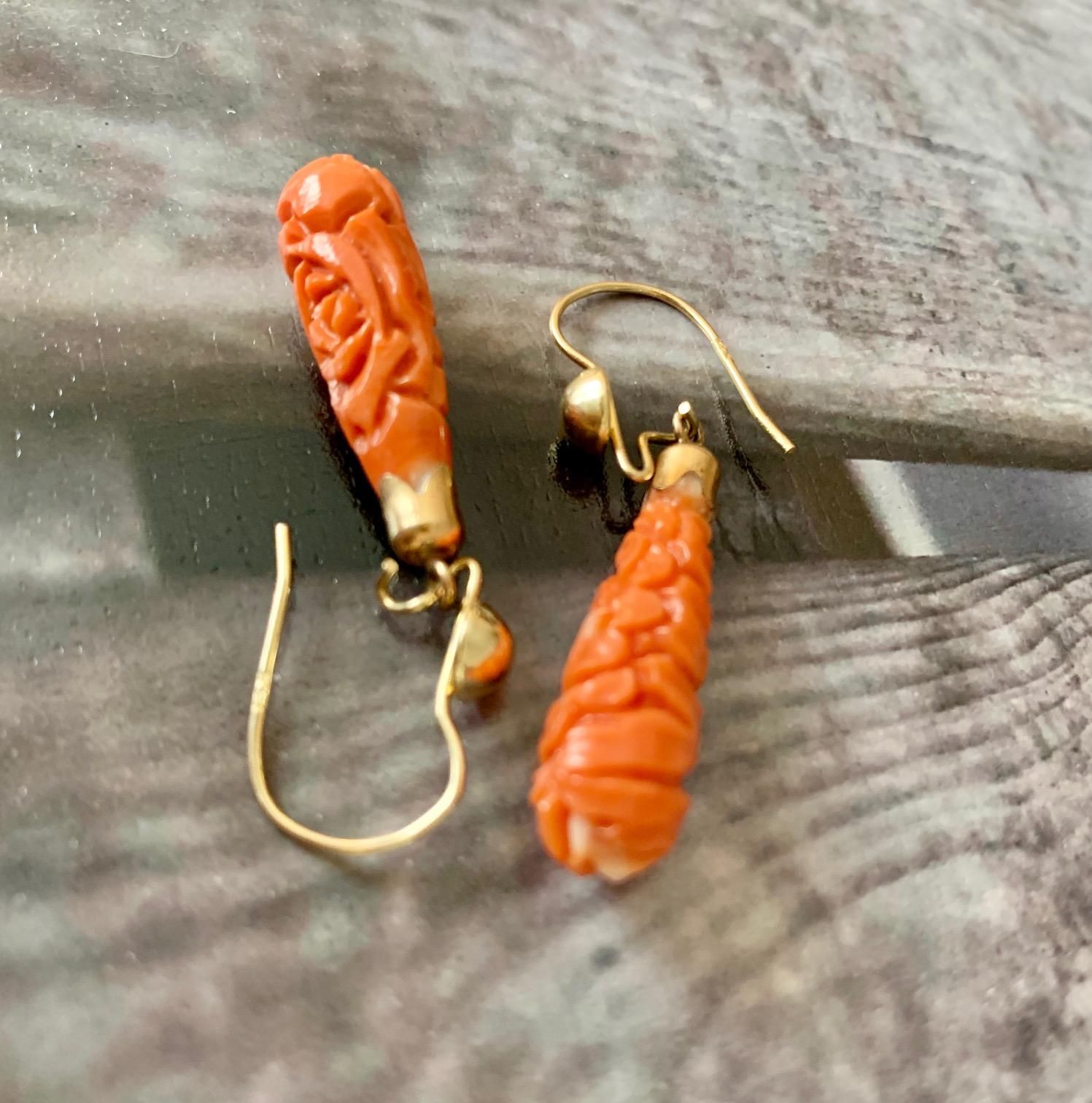 These earrings are stunning.  The workmanship is so lovely.  Each earring features a teardrop shaped carved Coral stone with an ear wire hook closure for extra security while wearing. 

Length:  1 1/2