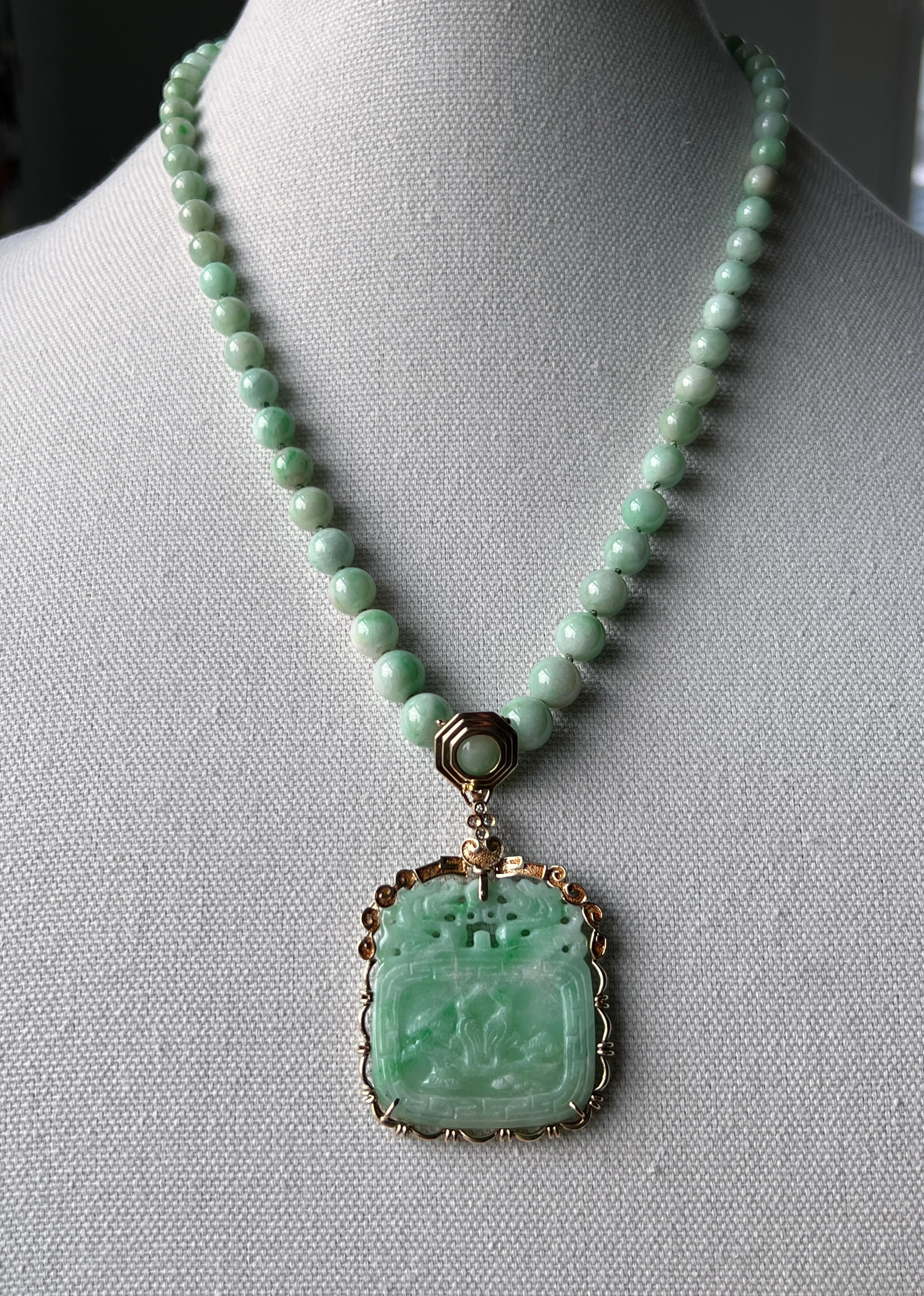 One vintage 1980s 21-inch graduated strand dyed jade necklace composed of sixty-four round beads measuring approximately 5 to 10mm. A detachable 37 x 40mm, 14k yellow gold framed, carved dyed jade is suspended from the the center bead. The carvings