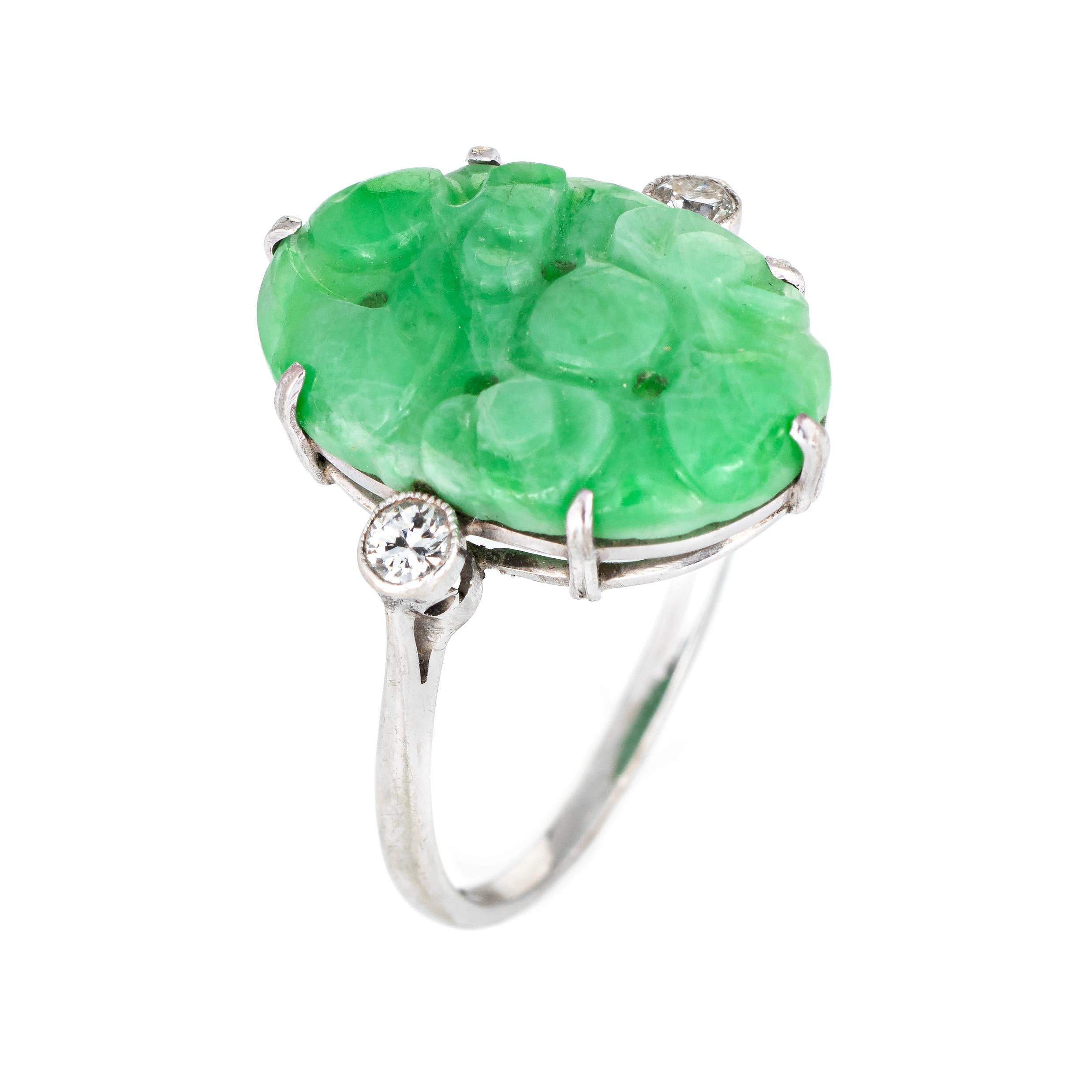 Stylish vintage carved jade & diamond cocktail ring (circa 1950s to 1960s) crafted in 18 karat white gold. 

Carved jade measures 18mm x 12.5mm, accented with two estimated 0.06 round brilliant cut diamonds. The total diamond weight is estimated at