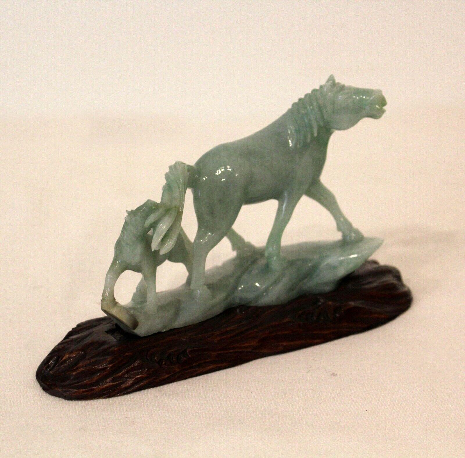 Incredibly detailed carved Jade Horse with Pony. Sculpture mounted on carved wood base specific to the piece. 
Dimensions: 6.25W x 2.25D x 4H.