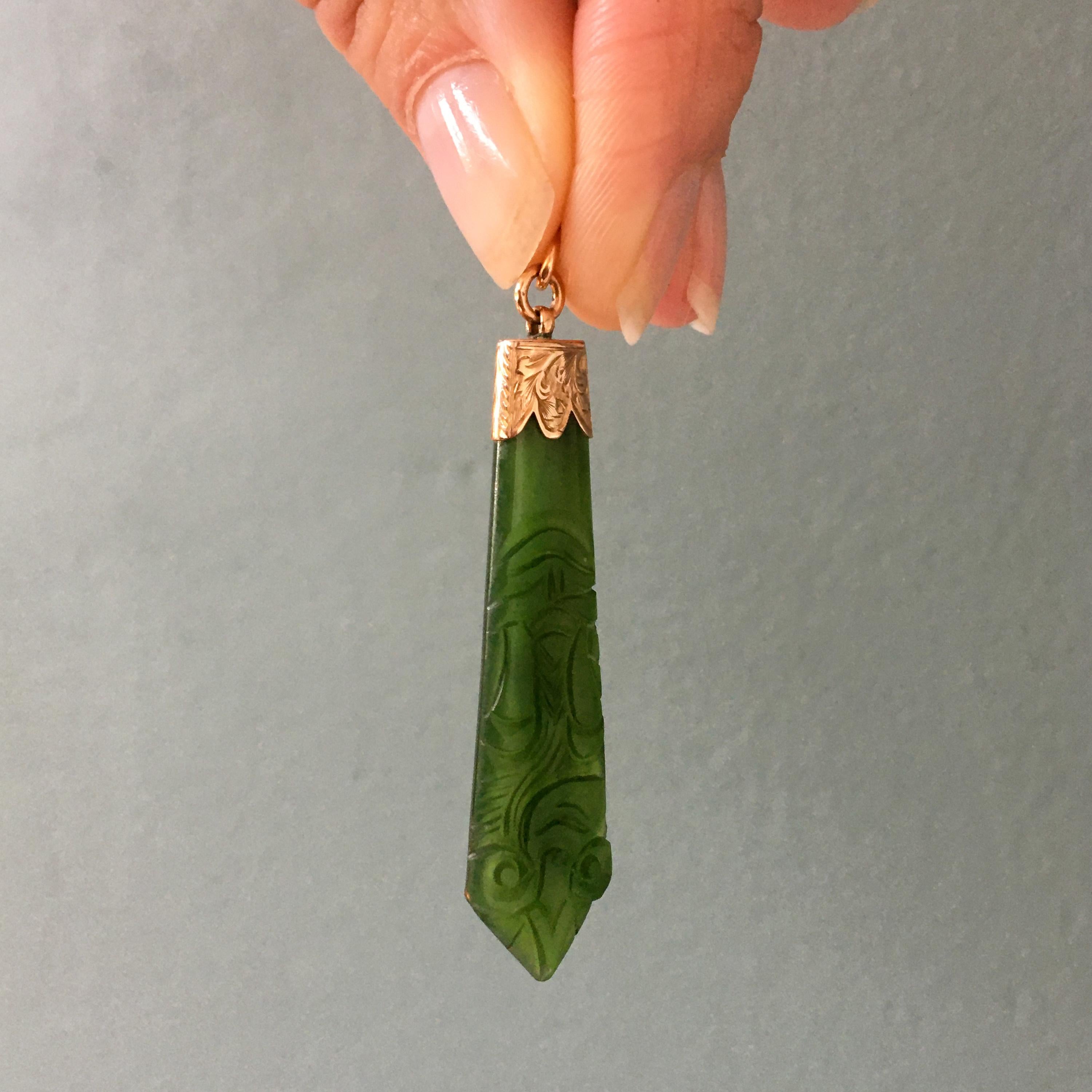 The stone of heaven. Jade carries the energy of the earth and nature, providing a wholesome, nurturing energy that uplifts and soothes the heart. A kite-shaped jade pendant is set in a gold engraved cap. The jade is cut in a super clean, beautiful