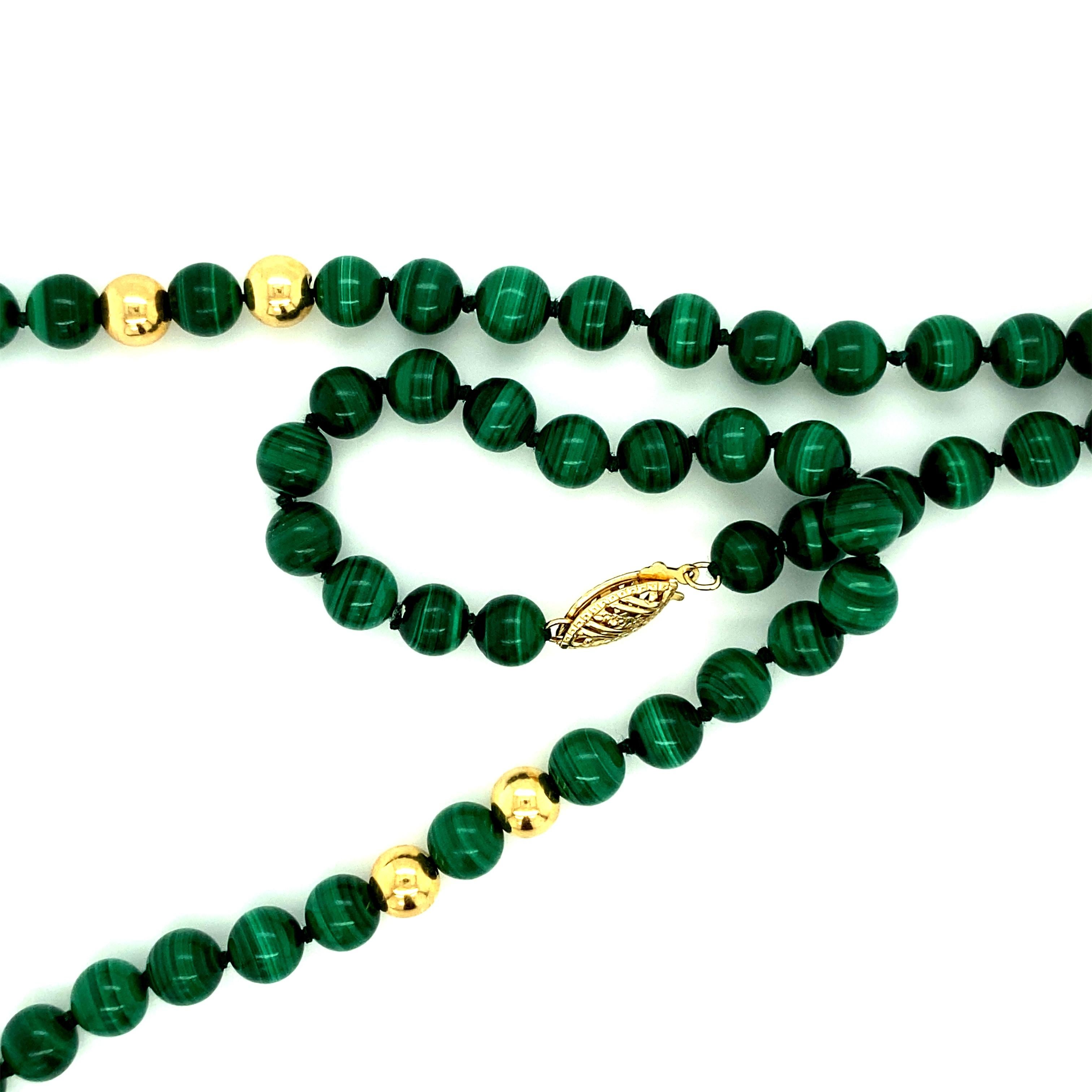 Vintage Jade carved with flowers & fish, 2” x 3/4”. 
Incredible craftsmanship. Chain is Malachite bead necklace 6.25 mm adorned with 14kt gold closure & beads. 
Weight: 65.1 gr
Size: 24”
