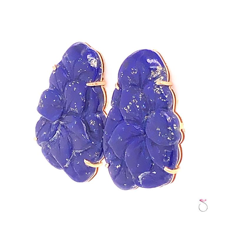 Beautifully carved Lapis Lazuli floral earrings in 14k yellow gold. These gorgeous earrings has a deep blue Lapis with gold veins. The carving is beautifully detailed on this lapis set in four prongs on a 14k gold frame. The earrings have post backs