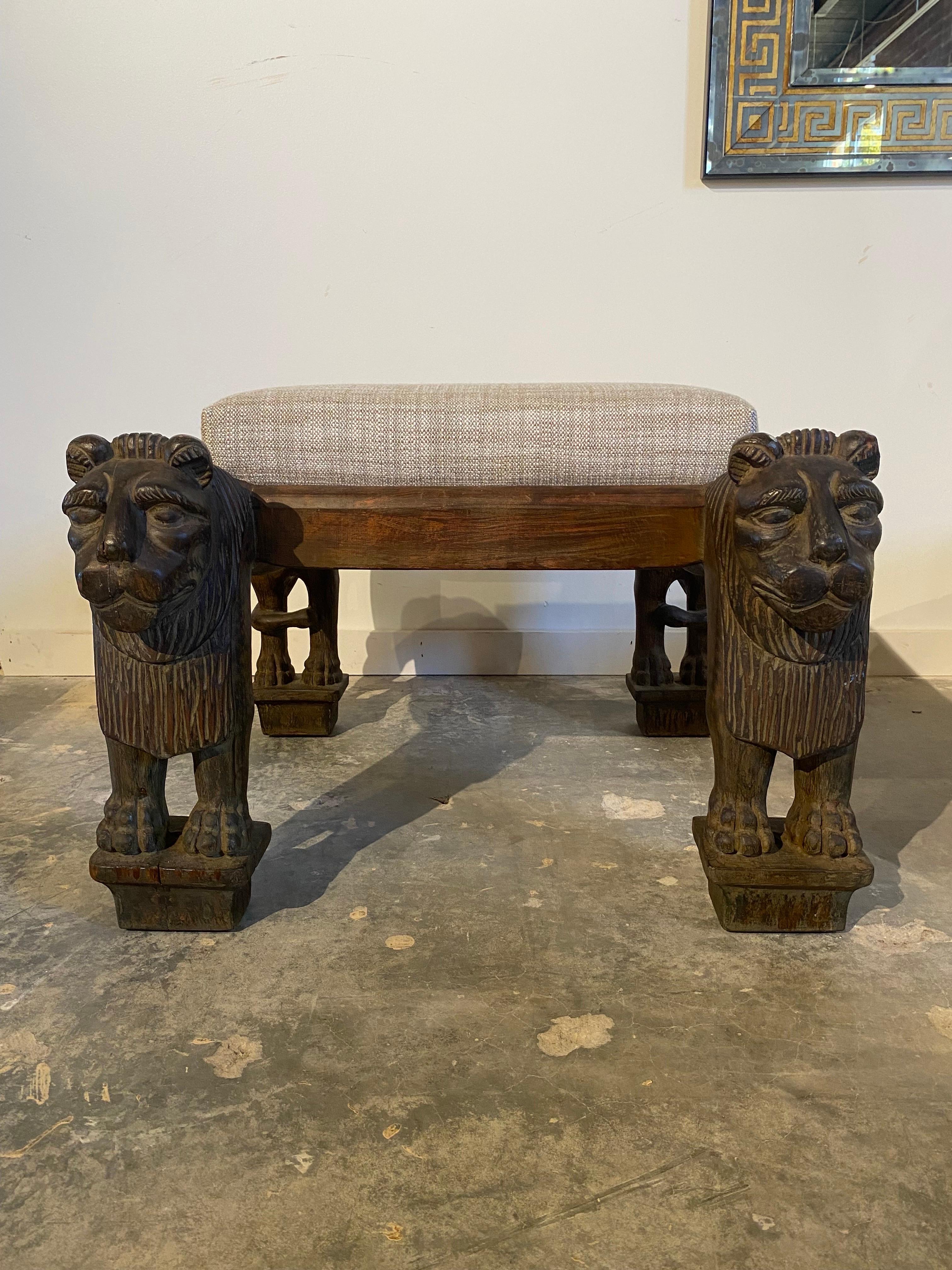 Intricately carved lion benches in the style of Maison Jansen. Newly upholstered in a textured heavy cotton weave.