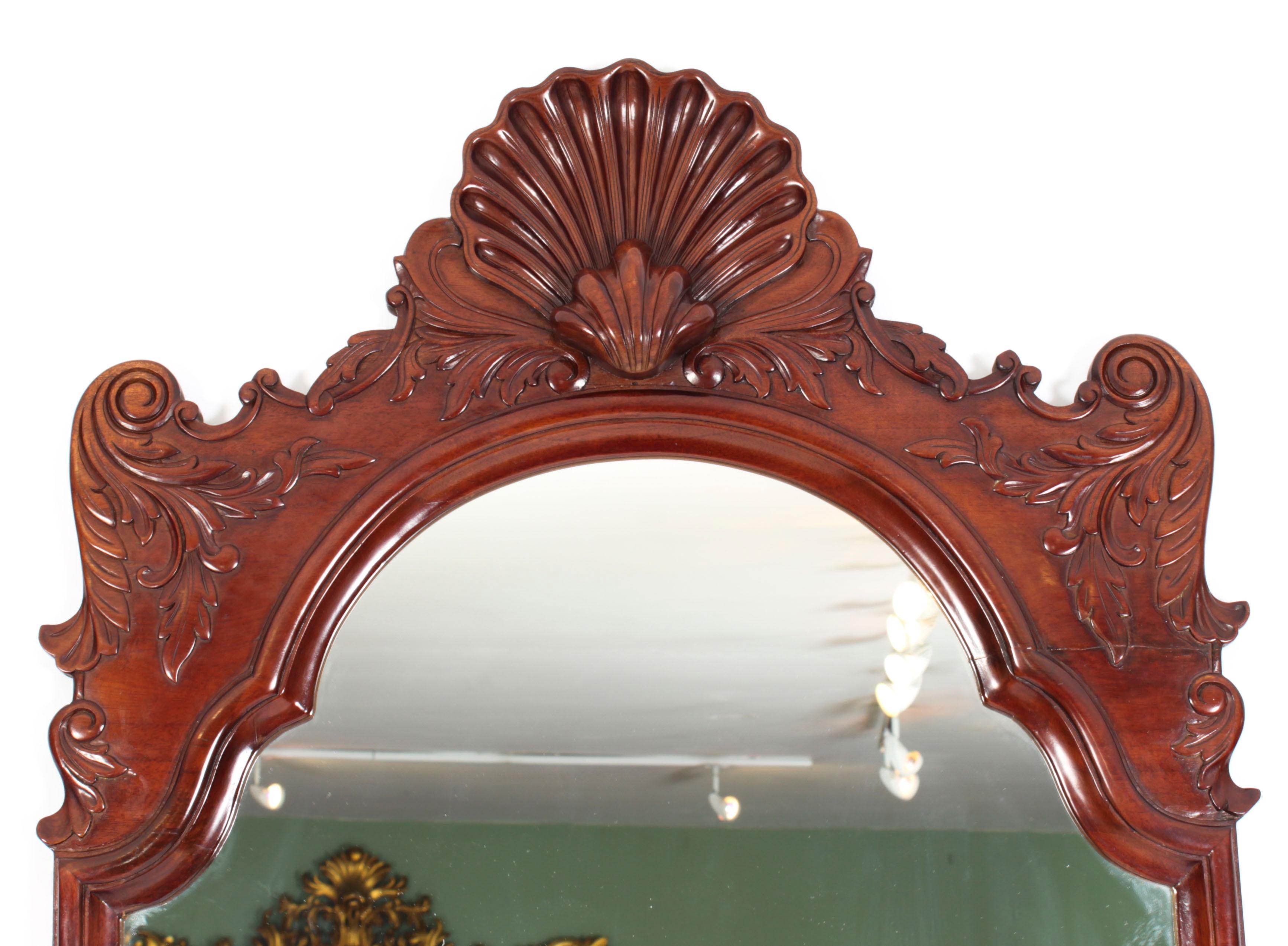 This is a superb contemporary  mirror, dating from the mid 20th Century.

The mirror plate is within a boldly-carved mahogany frame with scrolling foliate and decoration.

This is a very decorative item which will look amazing in any room.

THE