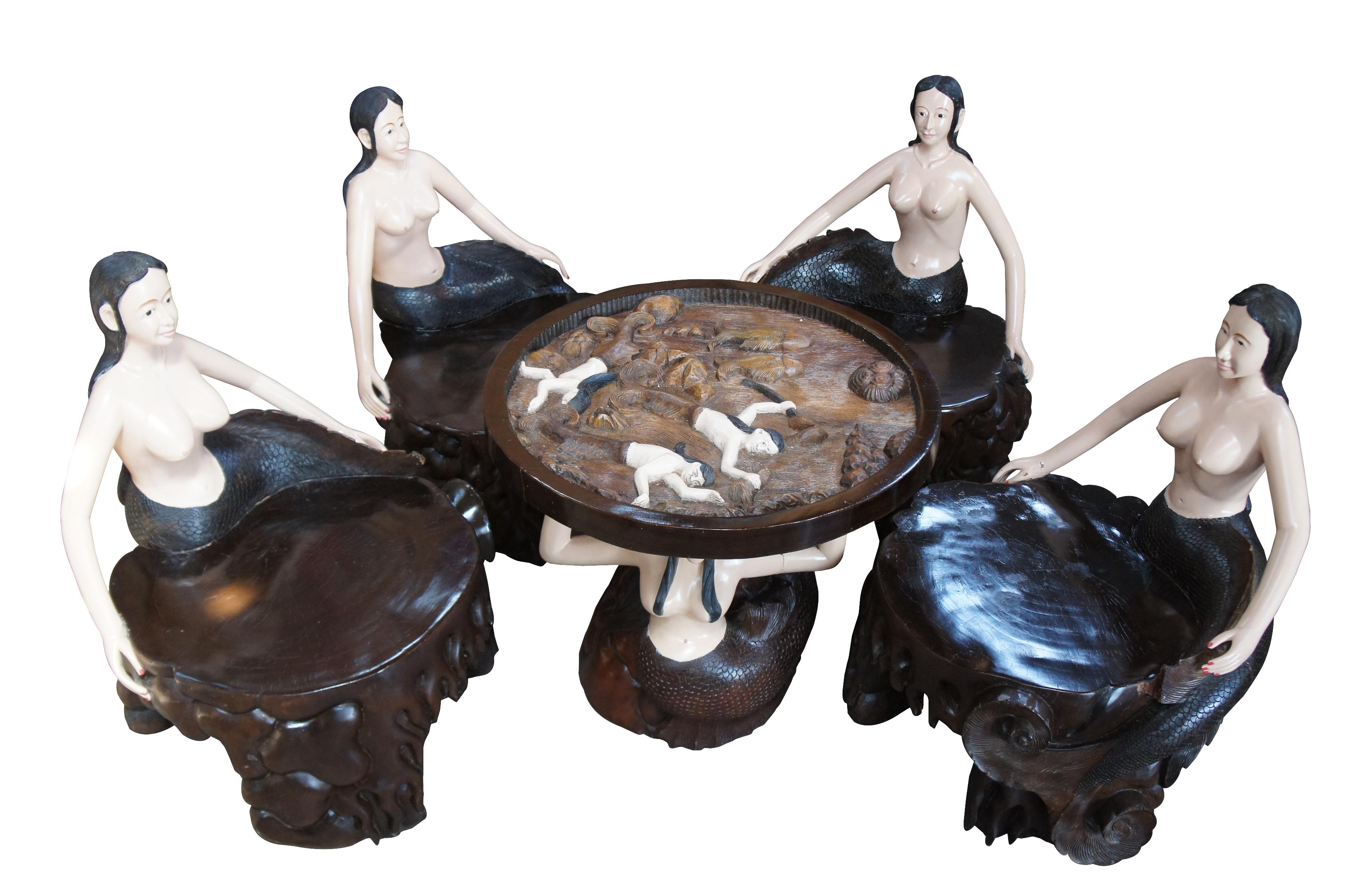 Vintage carved nude figural mermaid card game table and chairs nautical poker bali

Up for consideration is a handcrafted mermaid card table set from Bali, Indonesia. Features 4 nude mermaid chairs and mermaid table with glass top. Each piece is
