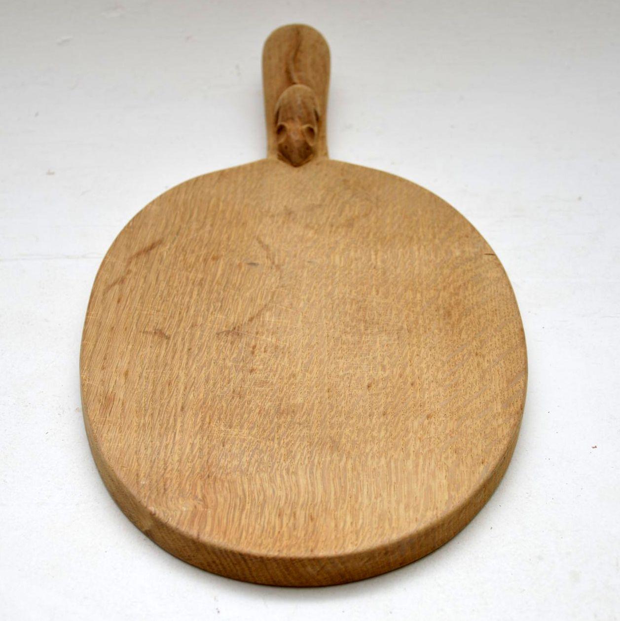 This is a vintage oak cheeseboard by the famous Robert ‘Mouseman’ Thompson made in the 1960s. These pieces are highly collectable and selling for a lot of money in some auctions and other sites.

Measures: Width – 16 inches, 41 cm
Depth – 8