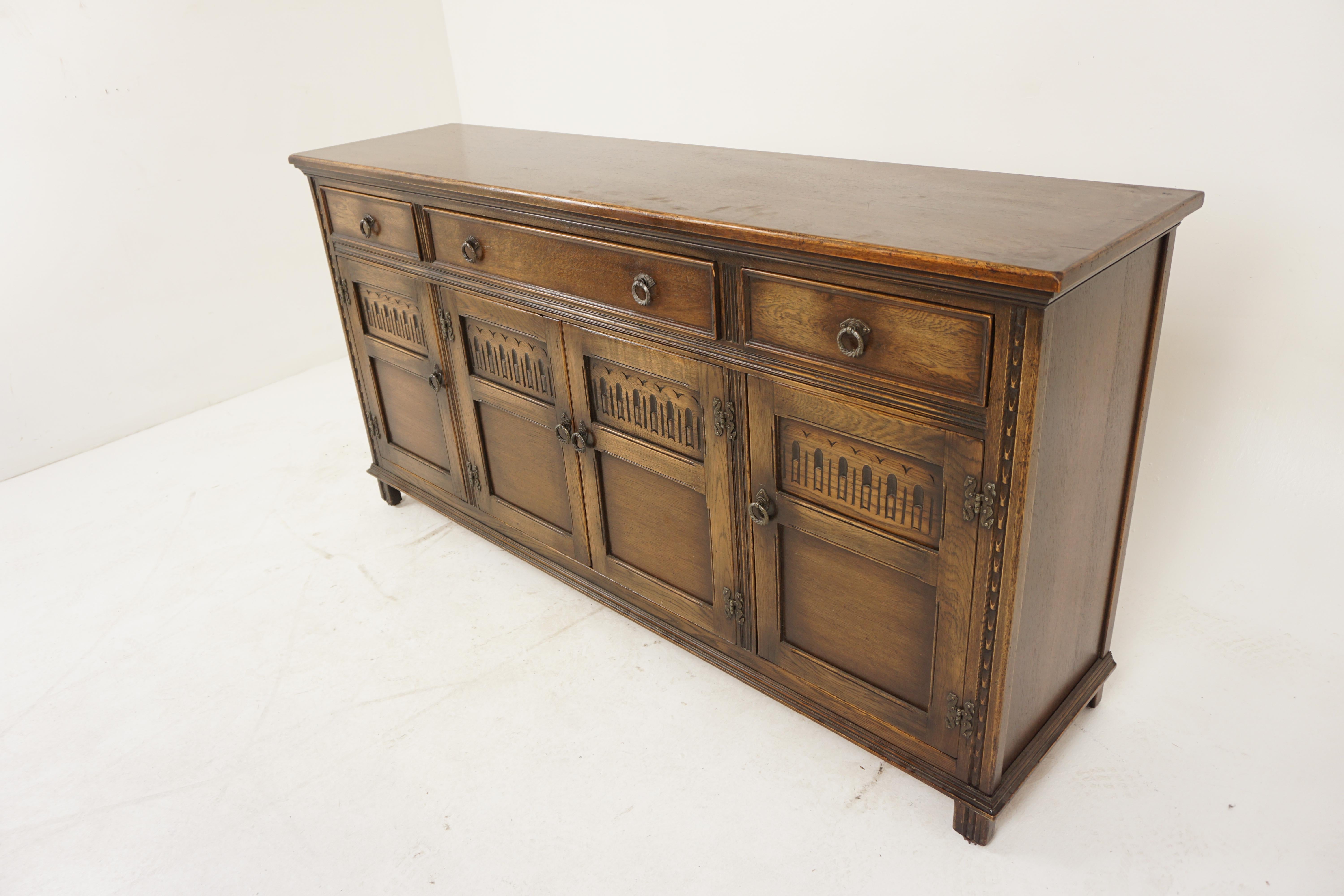 Vintage Carved Oak Sideboard Buffet Console, Scotland 1940, H1154

Solid Oak
Original finish
Rectangular moulded top
Two short and one long drawer underneath with original handles
Four carved panelled doors open to reveal single shelves in all