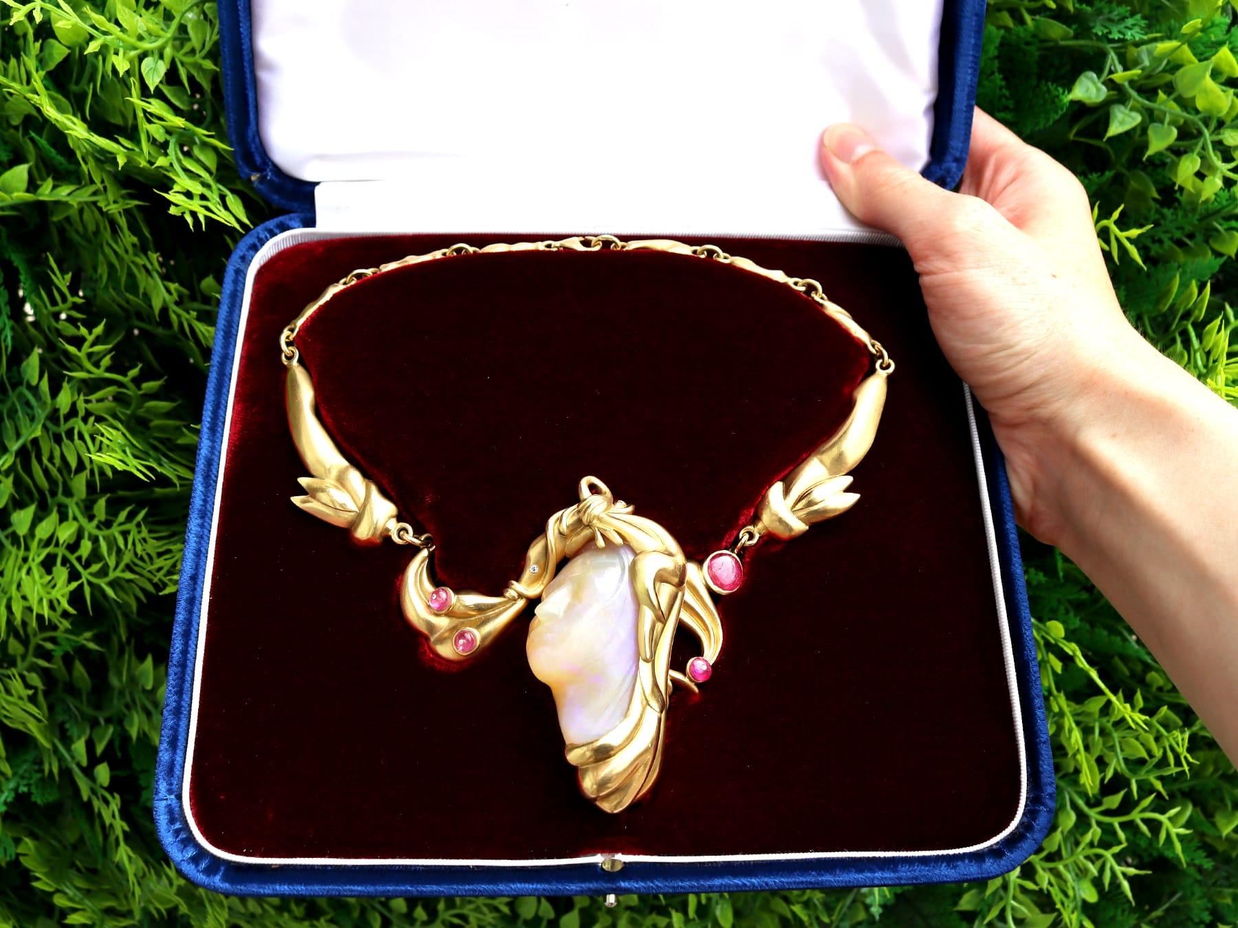 A magnificent, fine and impressive vintage carved opal, 4.80 carat ruby and 0.05 carat diamond, 18k yellow gold necklace - boxed; part of our diverse collection of vintage necklaces. 

This magnificent, fine and impressive vintage opal necklace has