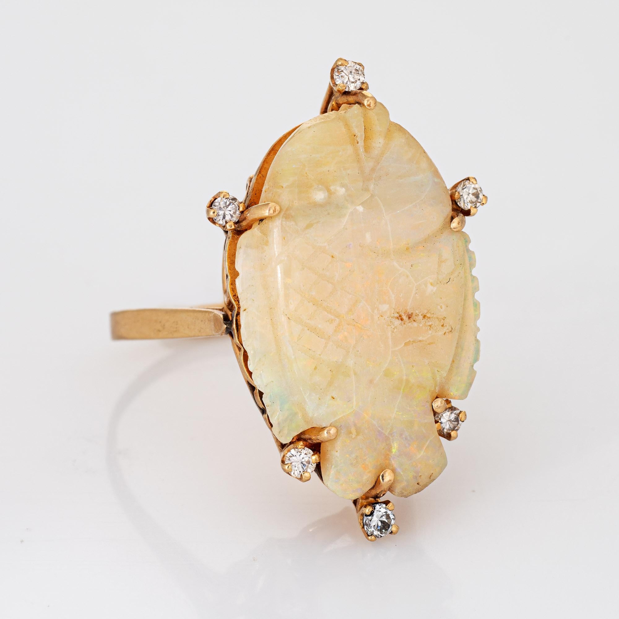Distinct & unique carved opal fish ring crafted in 14 karat yellow gold (circa 1960s to 1970s). 

The carved opal measures 27mm x 18mm, accented with 6 estimated 0.02 carat round brilliant cut diamonds. The total diamond weight is estimated at 0.12