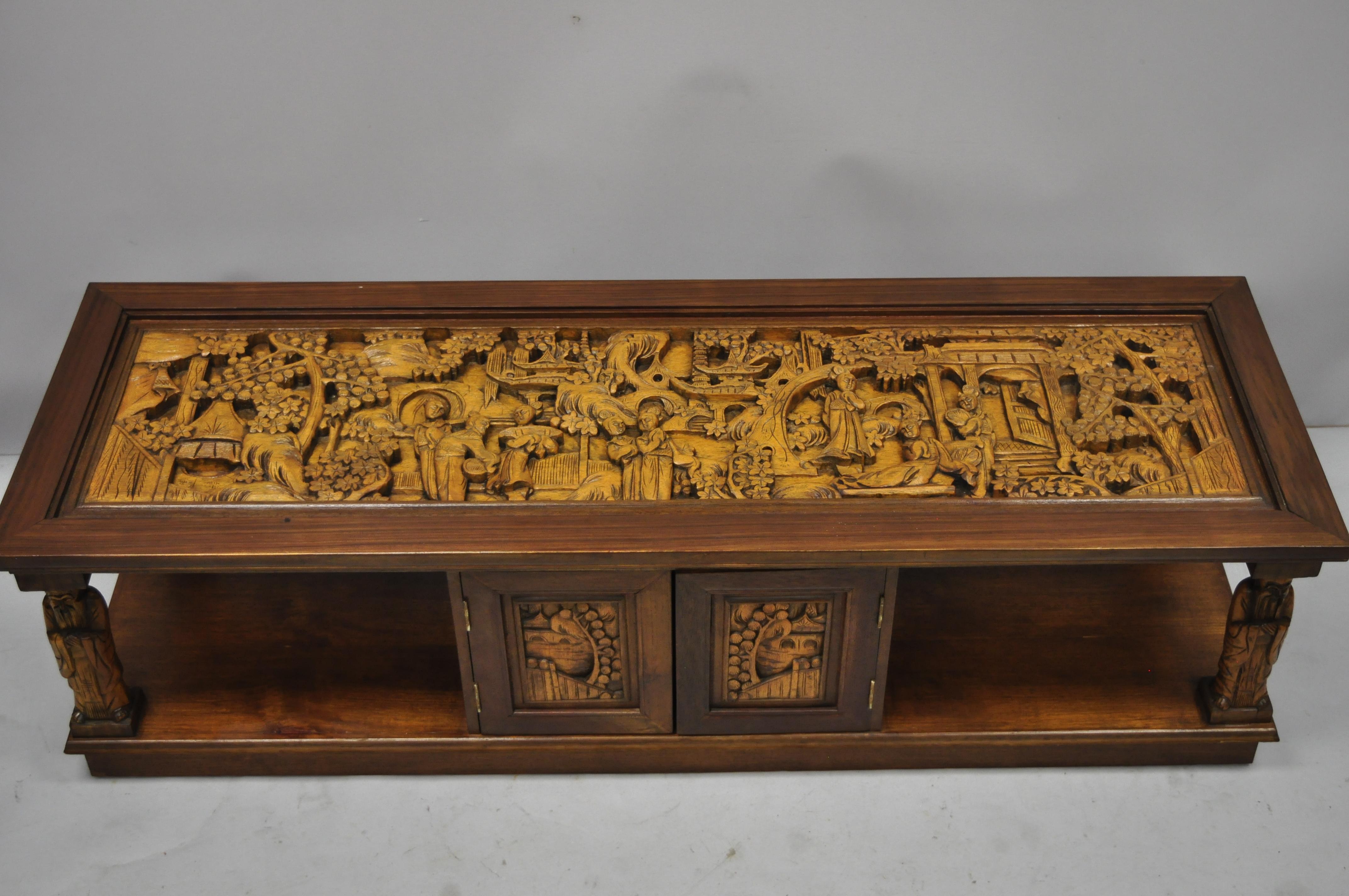 Vintage oriental Asian figural carved coffee table cabinet. Item features ornately carved figural top, cabinet doors on both sides which opens through, carved wood Wiseman column supports, glass top, very rare and unique coffee table, circa mid-20th