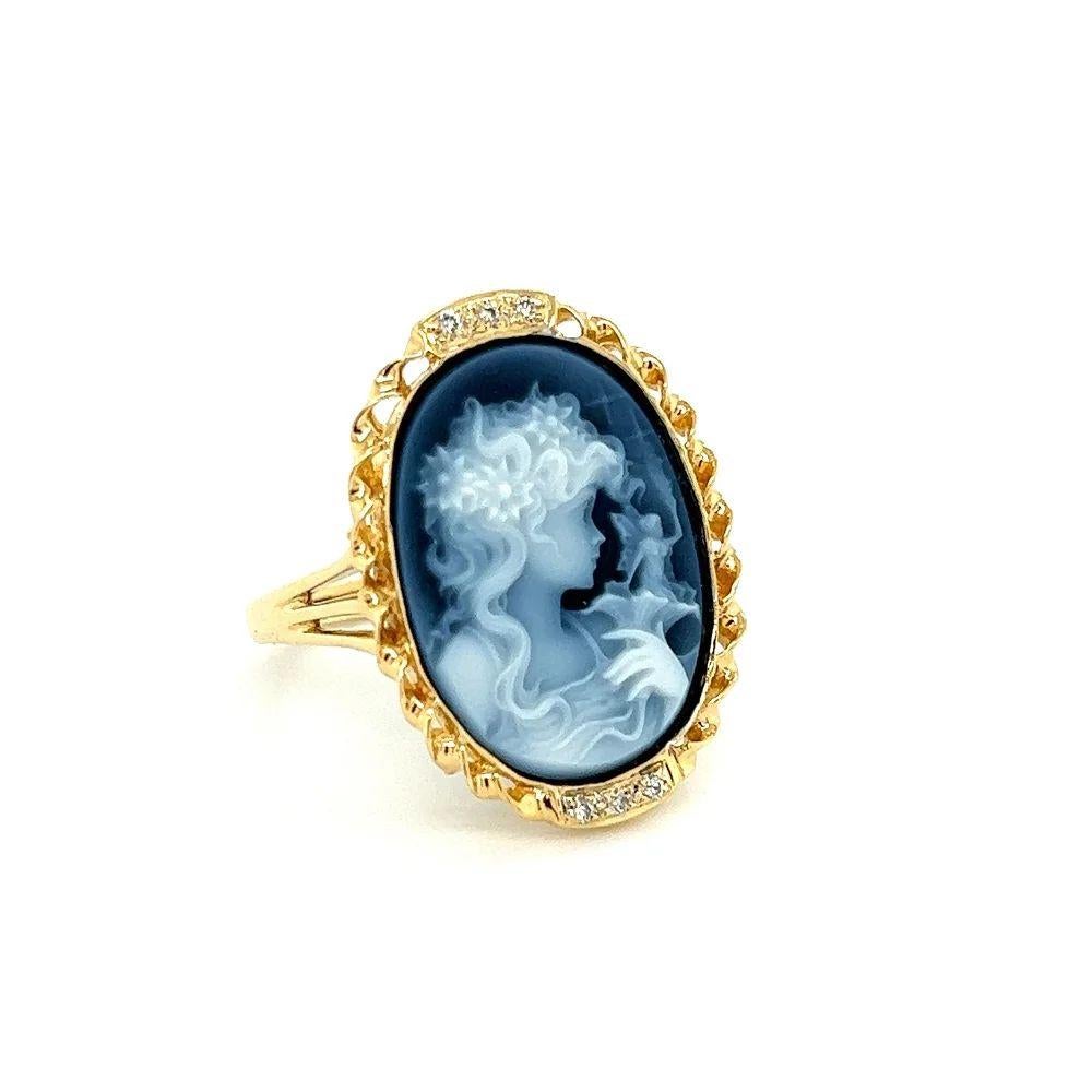 Simply Beautiful! Elegant and finely detailed Carved Onyx Cameo Gold Ring. Hand set with a securely nestled Hand Carved Oval Onyx Cameo depicting a Beautiful Lady’s face and a Fairy emerging from a flower. Enhanced with Diamonds, weighing approx.
