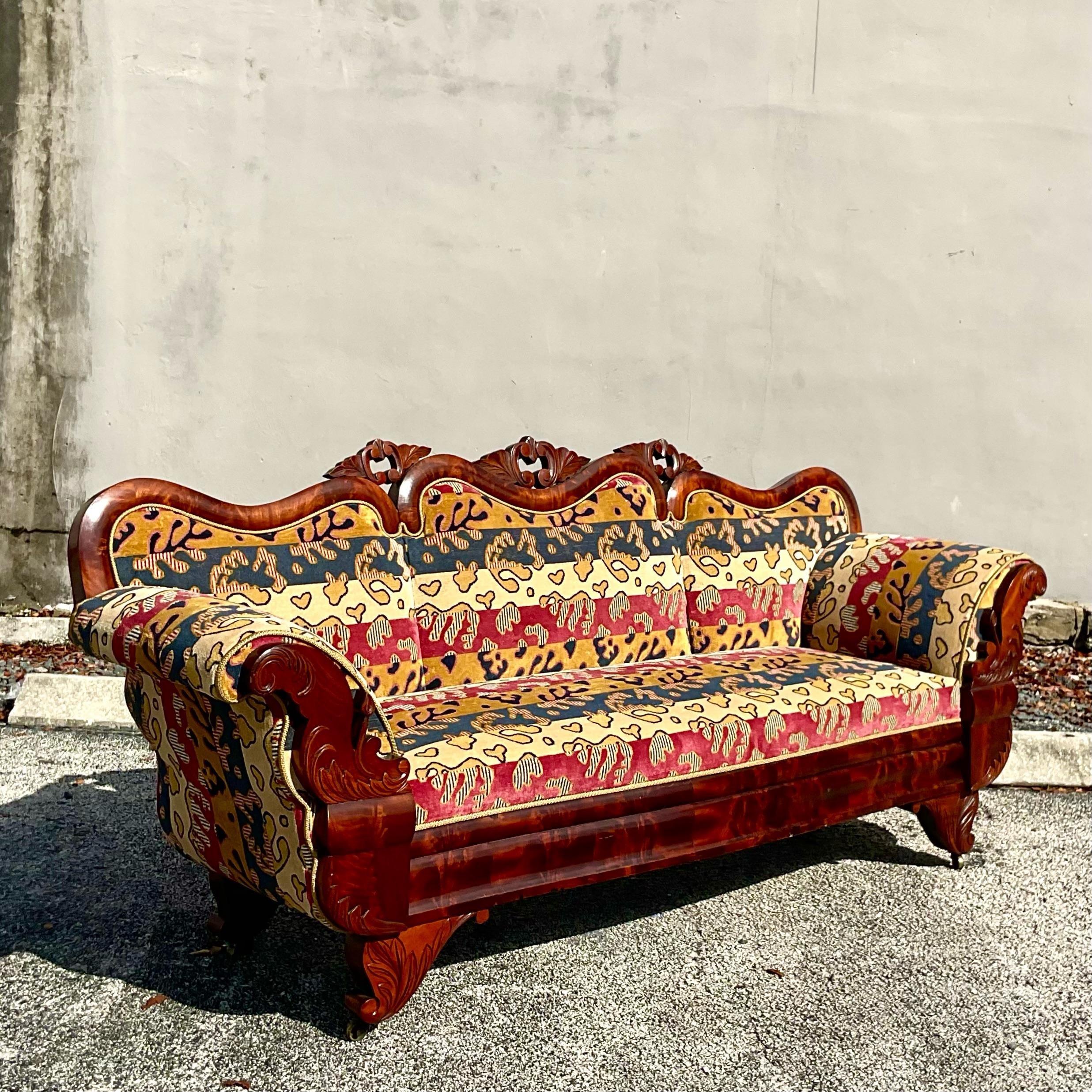 Dramatic elegant rococo style carved intricate sofa upholstered in Clearance House Amelie Linen Velvet in Navy Red fabric. This immaculate sofa is dripping in custom details from the woven fabric front with delicate wood carving crown and body