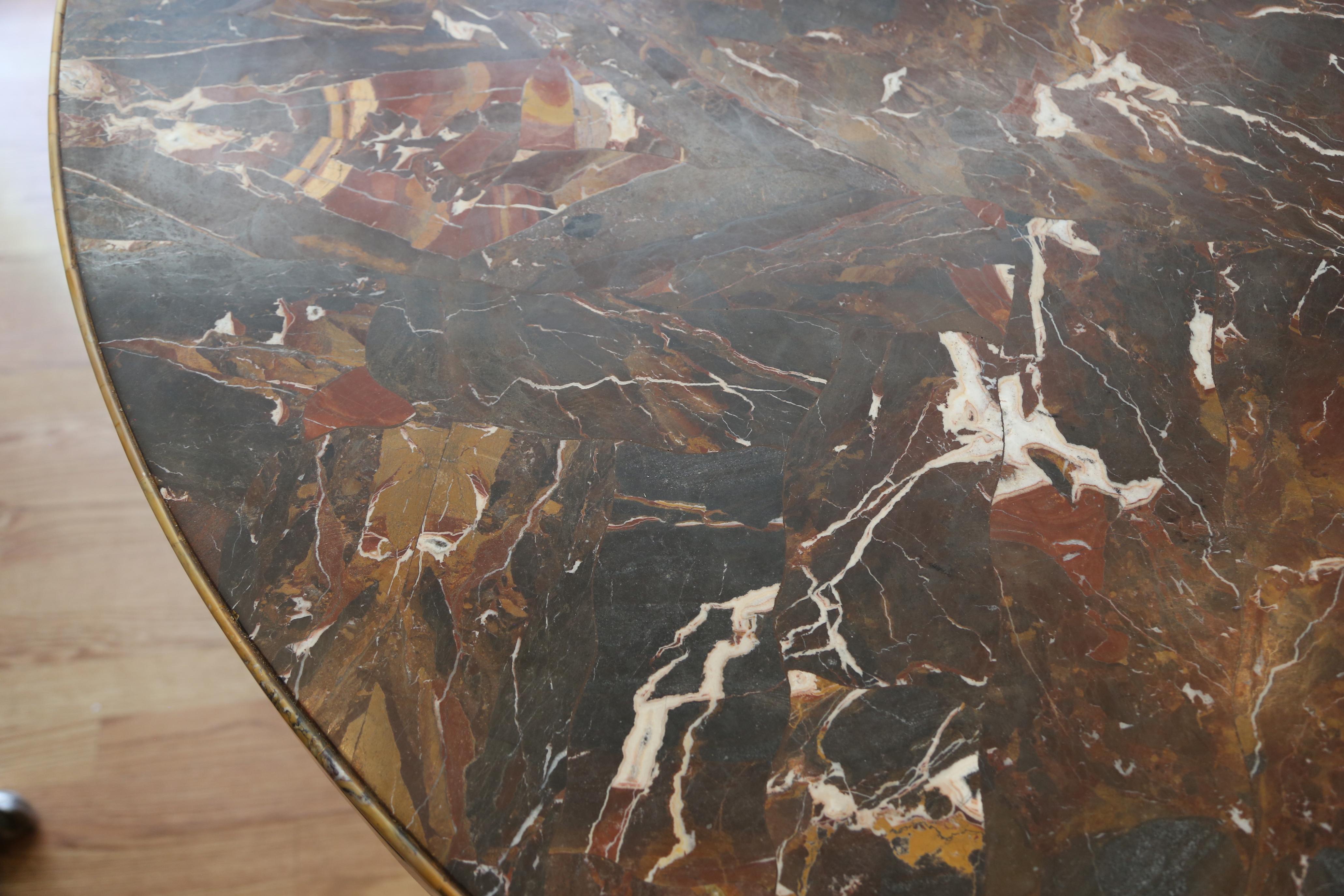 Solid marble table with intricately carved urn shaped base. Detailed edge on marble top.