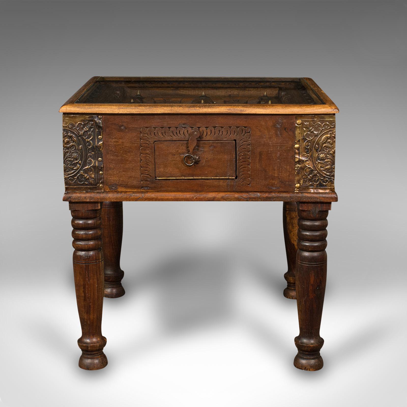 This is a vintage carved spice table. A Far Eastern, mahogany glass topped coffee or lamp table with brass mounts, dating to the late Art Deco period, circa 1940.

Fascinating table with a striking, carved inset gallery
Displays a desirable aged
