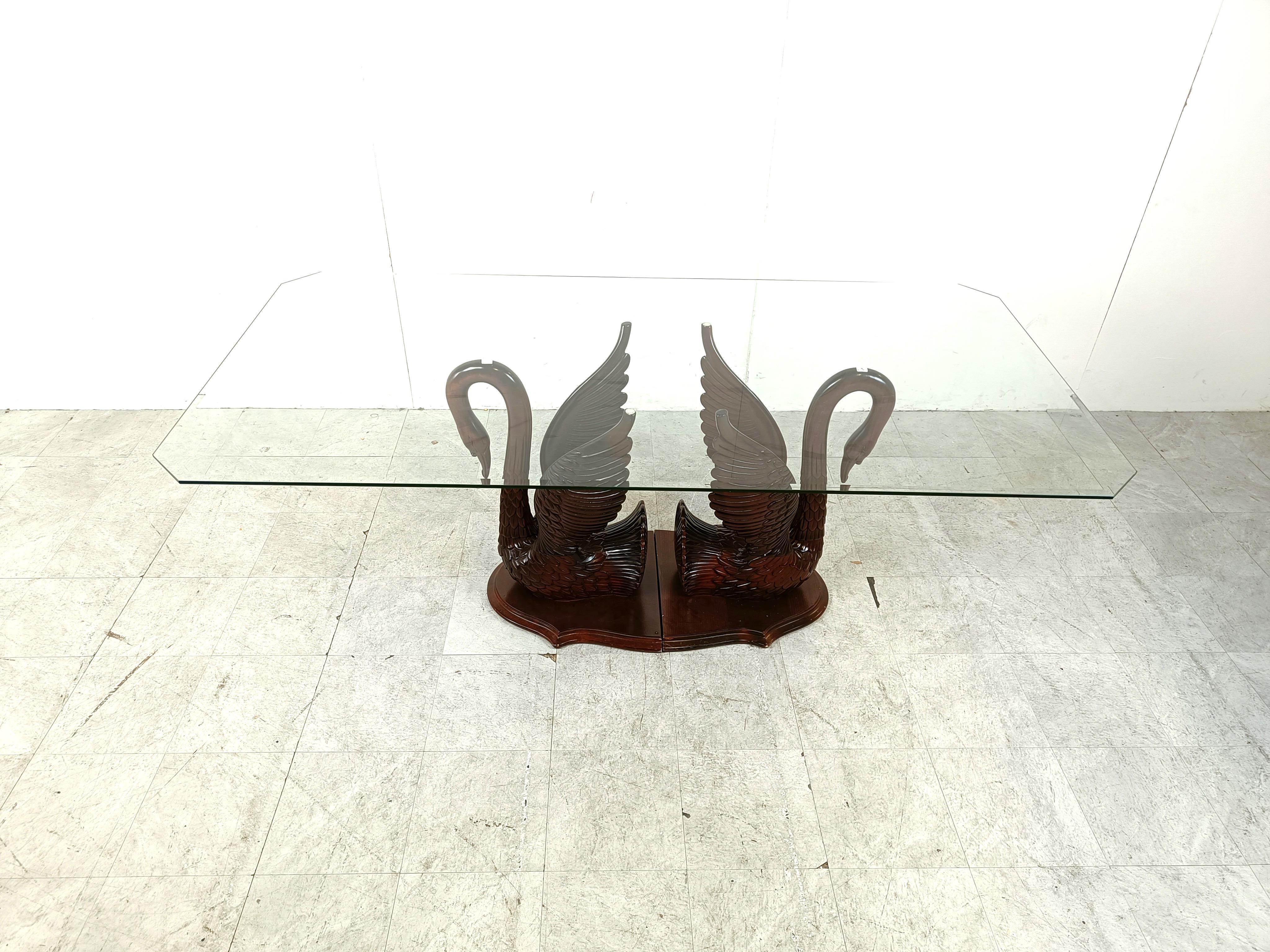Exquisite sculpted mahogany swan dining table with a clear beveled glass table top.

Beautifully carved sculpture.

Good overall condition

1960s - France 

Height: 76cm
Width: 200cm
Depth: 100cm

Ref: 103322