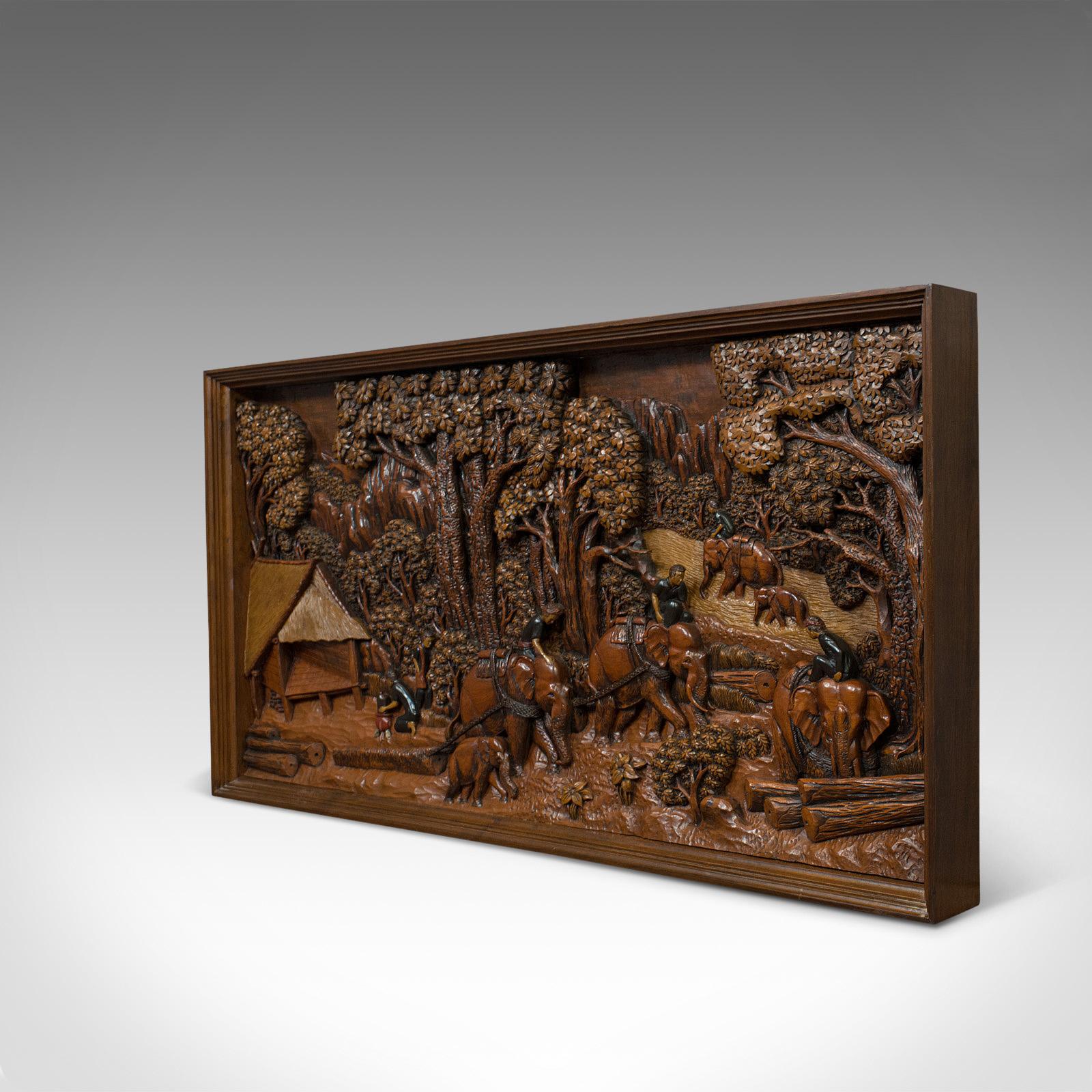 This is a vintage carved wall panel. An English, ironwood decorative frieze depicting a jungle clearing and dating to the 20th century.

Striking detail and broad, impressive form
Displays a desirable aged patina
Stocks of ironwood in good order