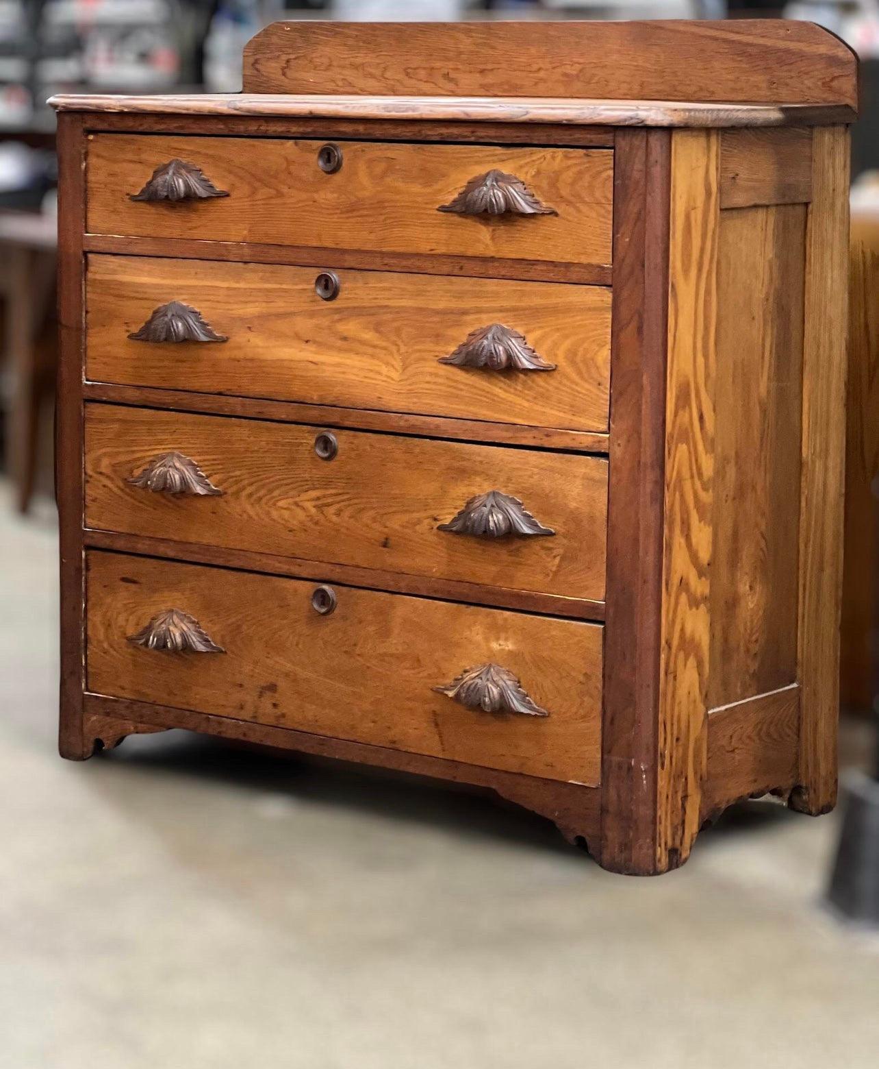Vintage walnut chest of drawers with carved wood and leaf drawer pulls. Drawers are put together with handmade dovetail joints. Well made with very old construction. Perfect for a rustic Primitive farmhouse decor! This is a beautiful piece with lots