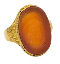 Vintage Carved Warrior Oval Cut Carnelian Cocktail Ring in 22 Karat Yellow Gold