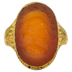 Vintage Carved Warrior Oval Cut Carnelian Cocktail Ring in 22 Karat Yellow Gold