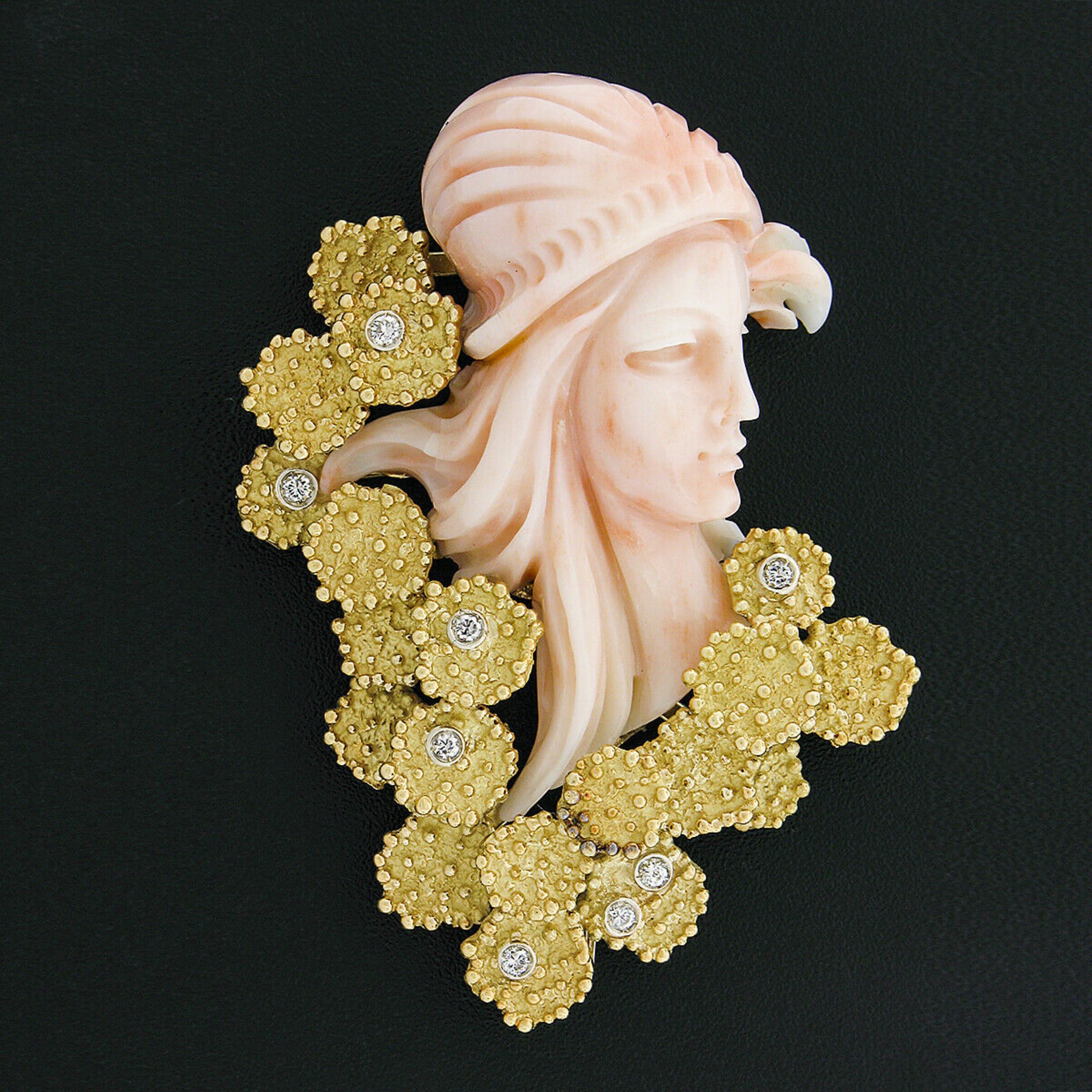 This outstanding vintage brooch/pin is crafted in solid 18k yellow gold and features a beautiful angel skin coral that is masterfully carved into showing an absolutely lovely and light angel skin color throughout and displays a detailed woman's face