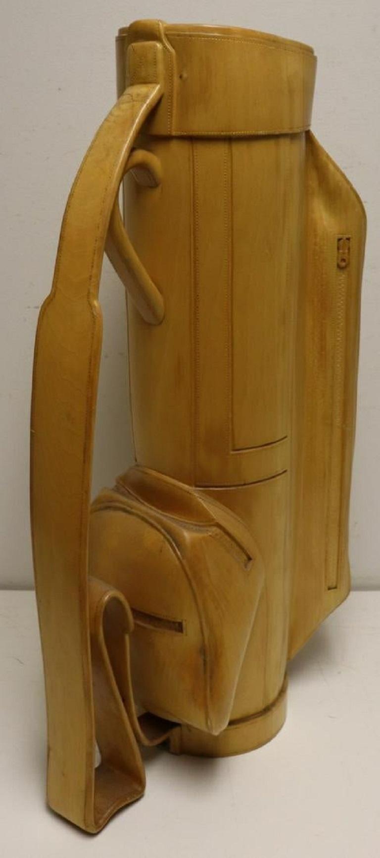 Heavily carved solid wood golf bag. Custom made and one of a kind. Nice item for a collector or golf enthusiast. Has a metal insert inside.