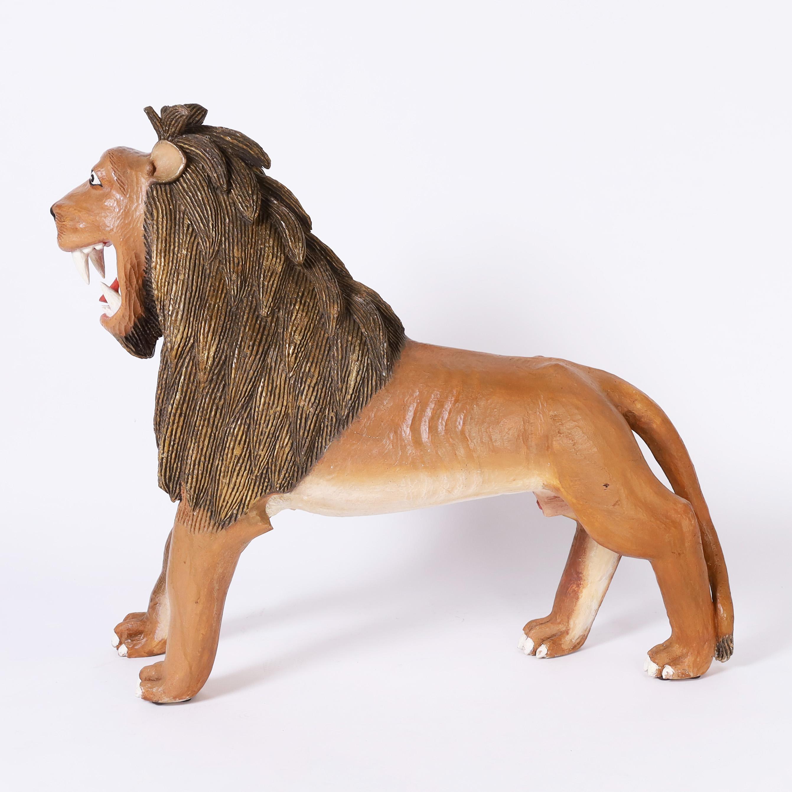 Eye catching whimsical lion sculpture or figure, hand carved, in a naive style, paint decorated and caught in mid roar.