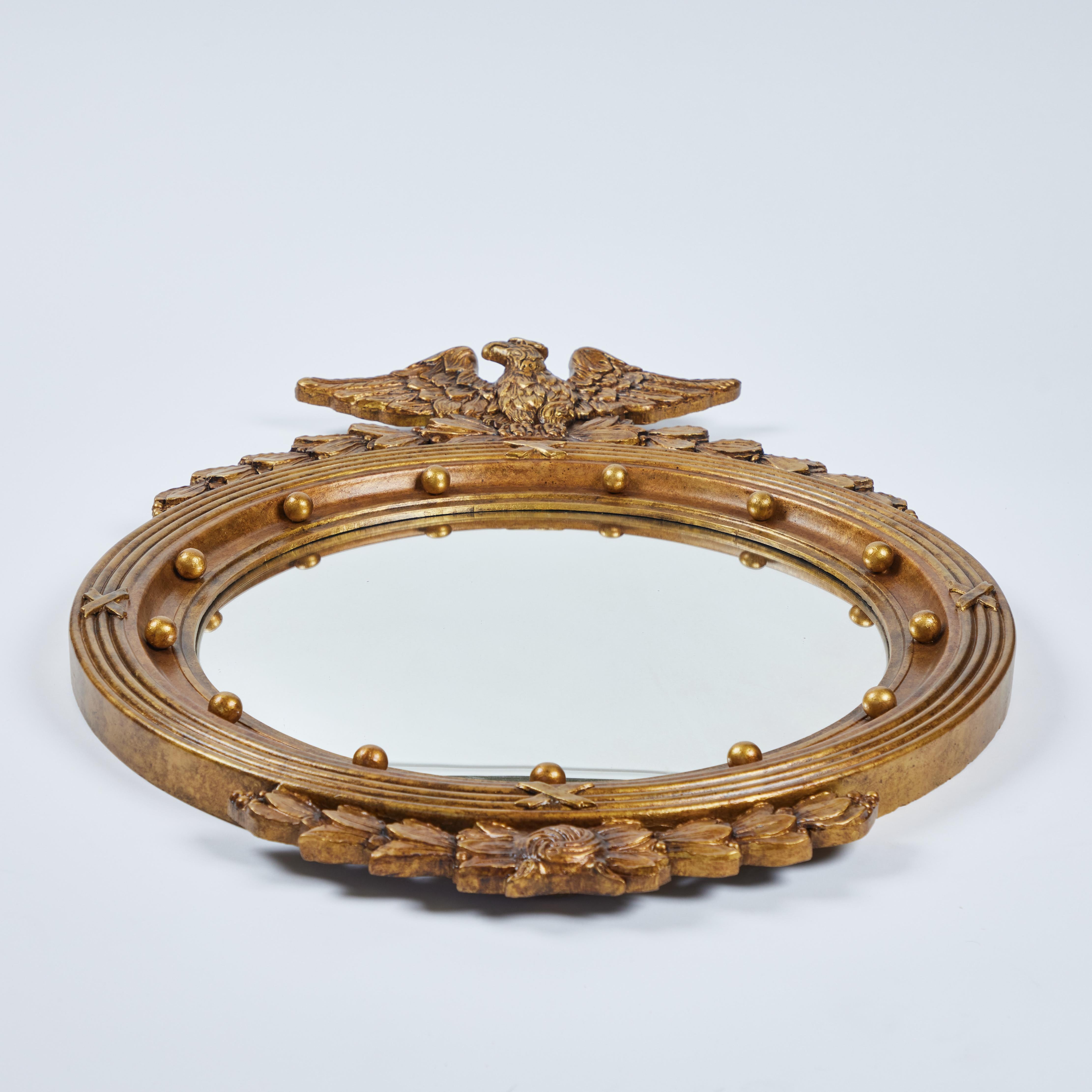 How striking is this vintage carved found wood convex mirror with an eagle on top caught our eye! It has been newly painted in a rich antique gold finish and it measures 23.25
