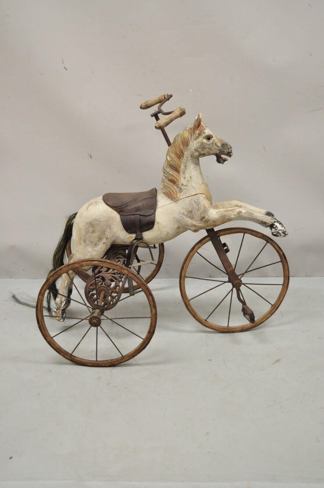 Vintage carved wood hobby horse wooden tricycle bike bicycle. Item features 
tricycle bike, carved wooden horse, distressed finish, iron hardware, glass eye, very nice vintage item, believed to be a reproduction. Circa mid-20th century.