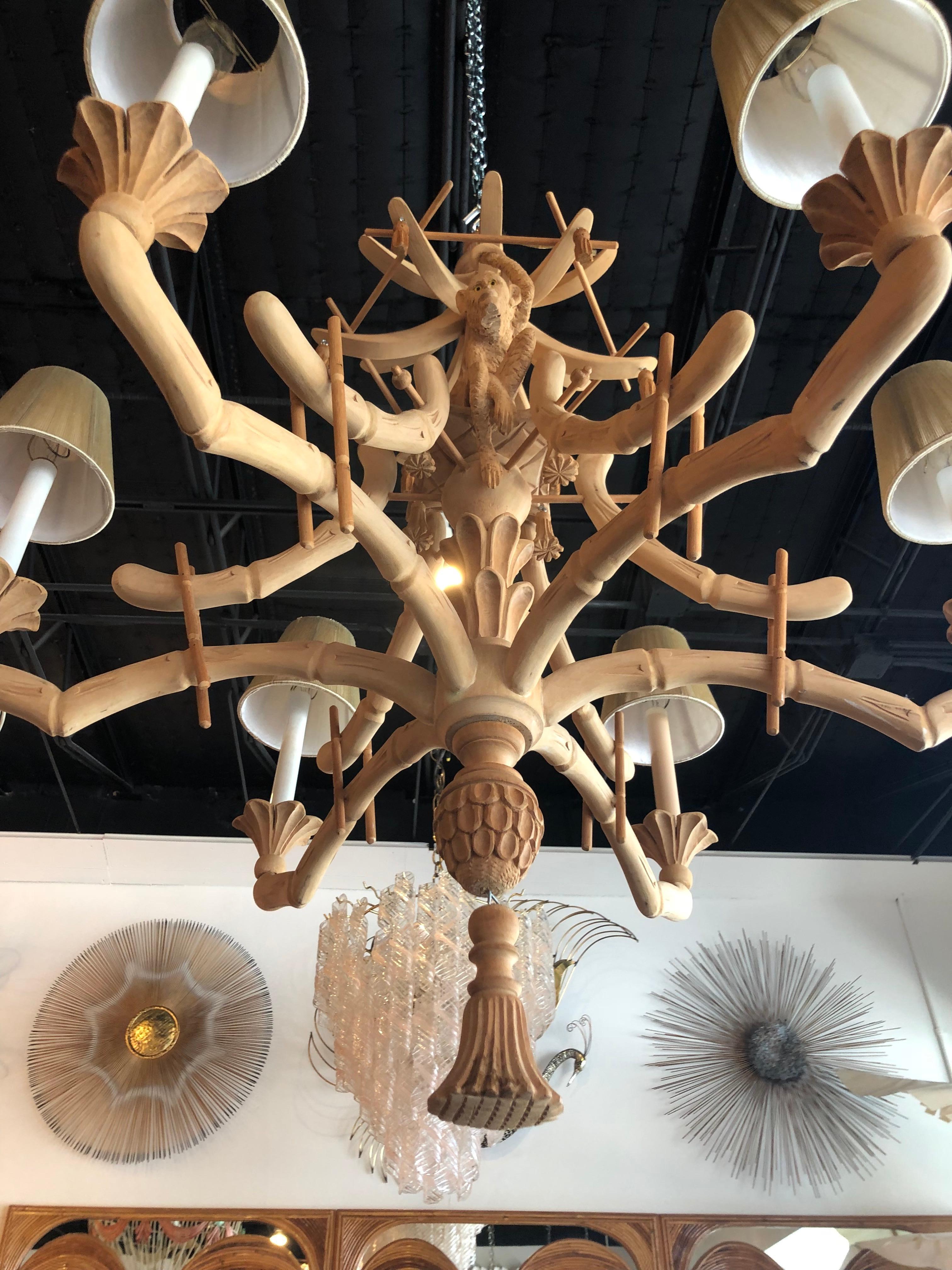 Amazing vintage carved wood monkey 6-light chandelier full of spectacular details, Pagoda top, bells, tassels, carved leaves, faux bamboo just to name a few! Original natural wood makes this perfect for a tropical Palm Beach feel! Candelabra covers