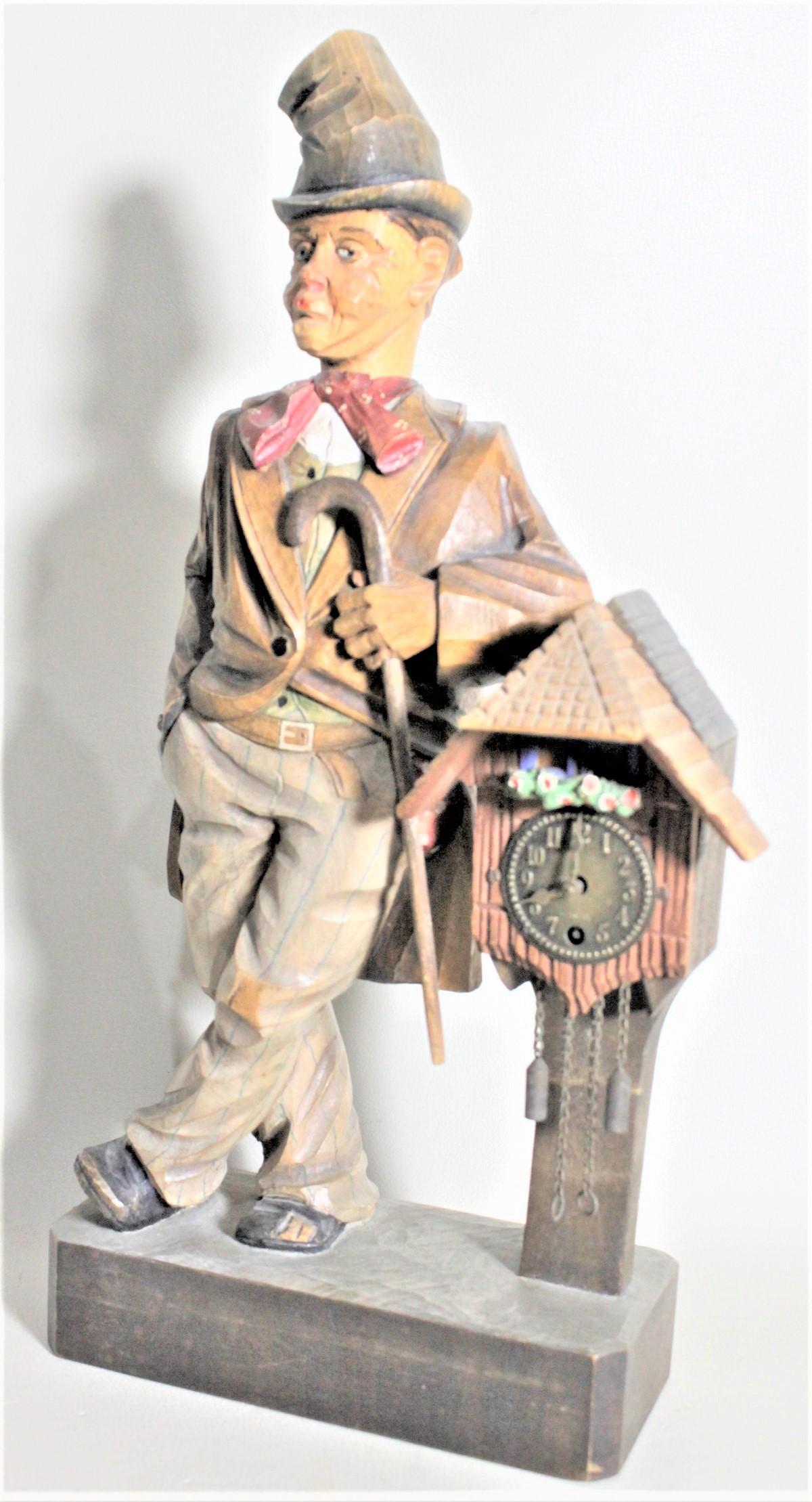 This vintage hand carved and hand painted musical clock is unsigned, but presumed to have been made in or near Austria in circa 1950 in a Folk Art style. The carving depicts a male figure leaning against a post mounted Black Forest styled clock. The